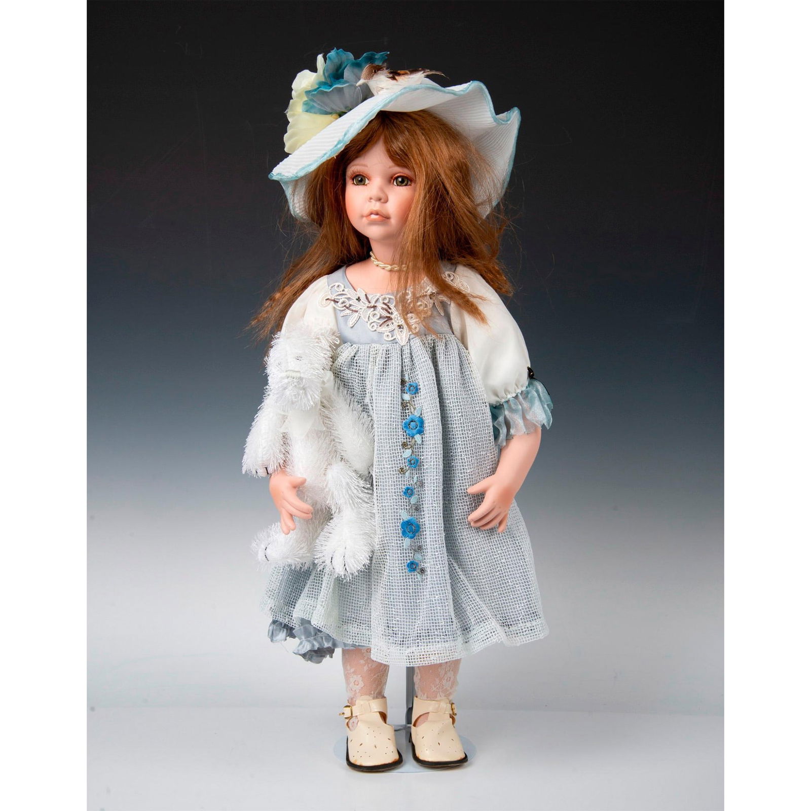 Vintage Duck House Porcelain Heirloom Doll, Lisha: Doll with a hat and plush white elephant. Certificate of Authenticity included. She comes in her original box, which measures 27"L x 10.25"W x 5.5"H. Issued: 20th c. Dimensions: 25.5"H Edition Number: