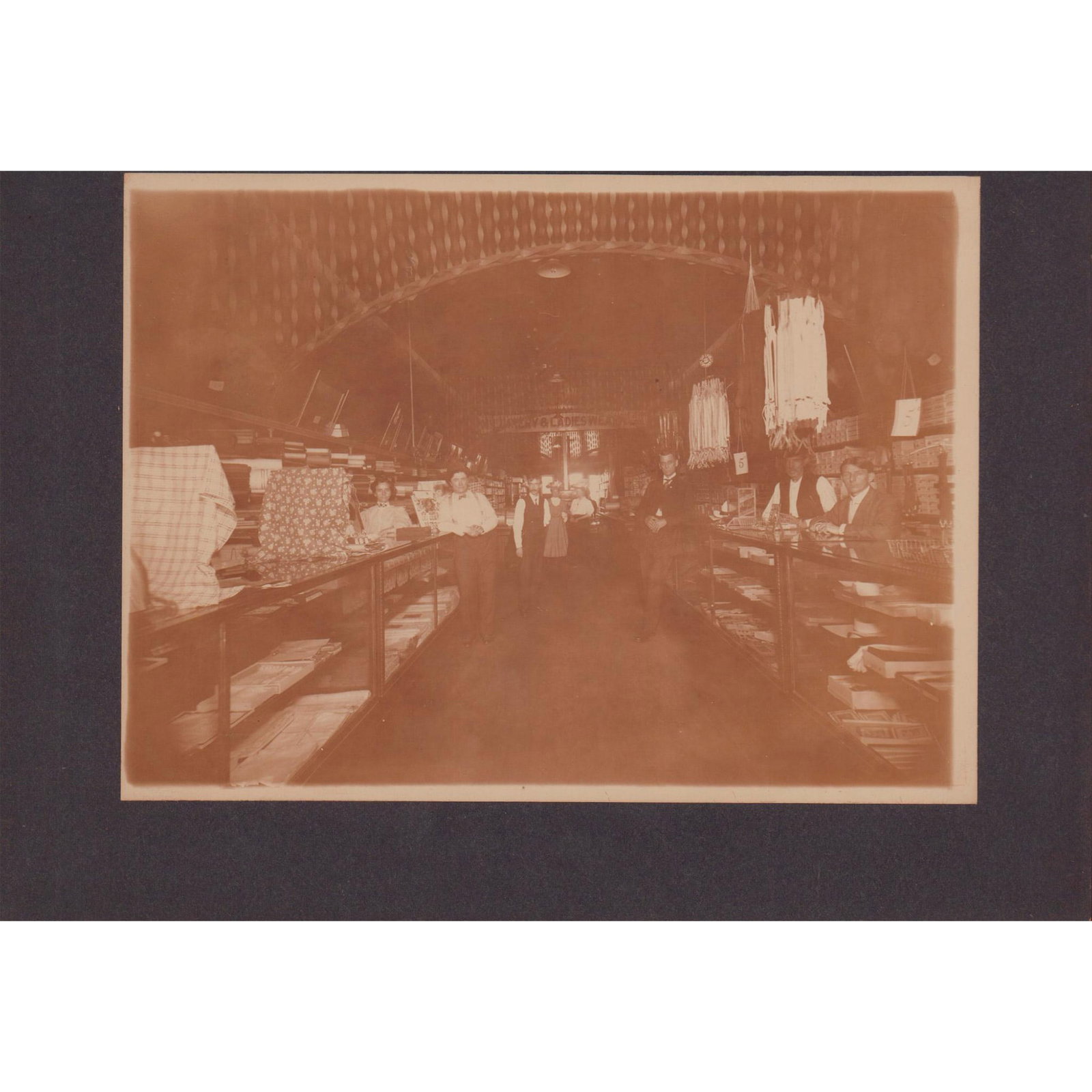 Antique Original Photo, Group Portrait in Ladieswear Store: Interesting photograph depicting three women and four men in Victorian or Edwardian attire inside a ladieswear store. Based on attire and hairstyles, photograph may have been taken around the 1890s or