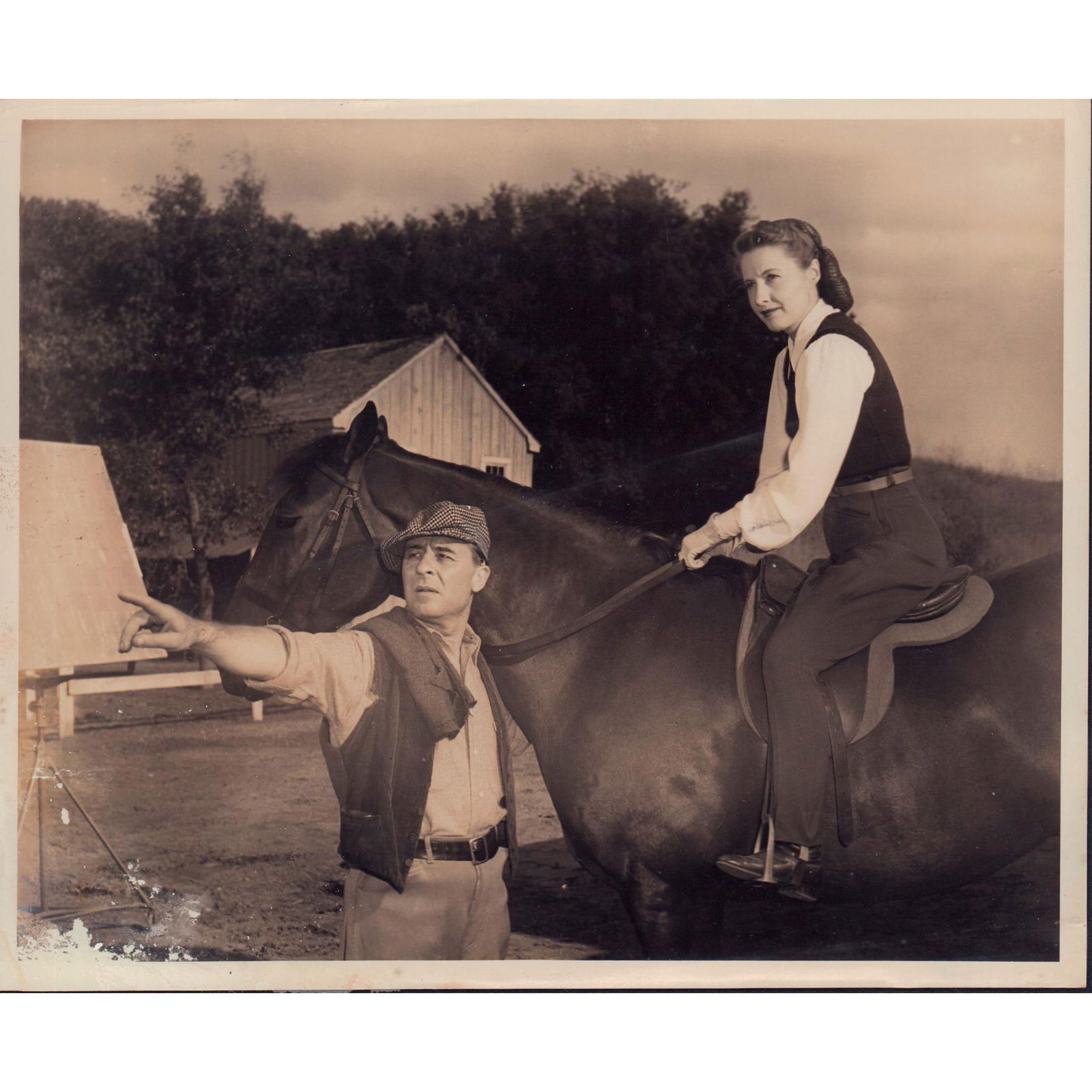 Photograph From Cry Wolf, Actors: Black and white photo with a scene from the film 'Cry Wolf', featuring Barry Bernard and Barbara Stanwyck. 'Barry Bernard, Barbara Stanwyck in Cry Wolf (4x5) A Warner Bros. First National Picture' glu