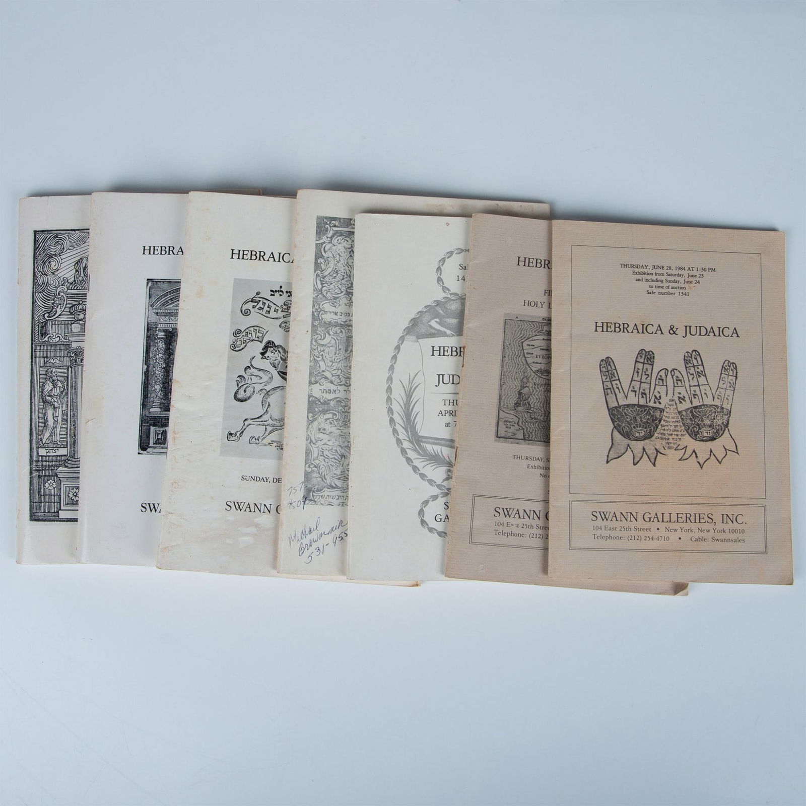 7 Swann Galleries NYC Judaica Auction House Catalogues: Set of seven auction house Judaica catalogues published between 1984-1987 by Swann Galleries, New York City. Combined catalogues dimensions: 6.50"L x 9.50"H x 1.50"W. Issued: 1984-1987 Country of Orig