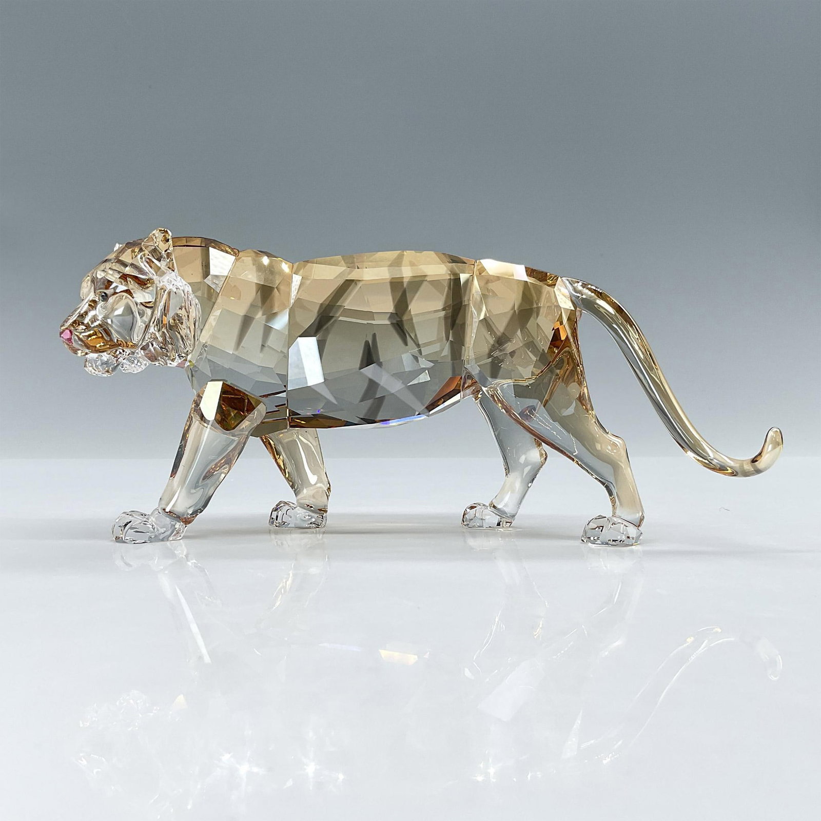 Swarovski SCS Figurine, Endangered Wildlife Tiger 1003148: To celebrate the Year of the Tiger, the final piece of the Endangered Wildlife Trilogy depicts this majestic animal. Its body shimmers in fully facetted Golden Shine crystal with Satin crystal stripes