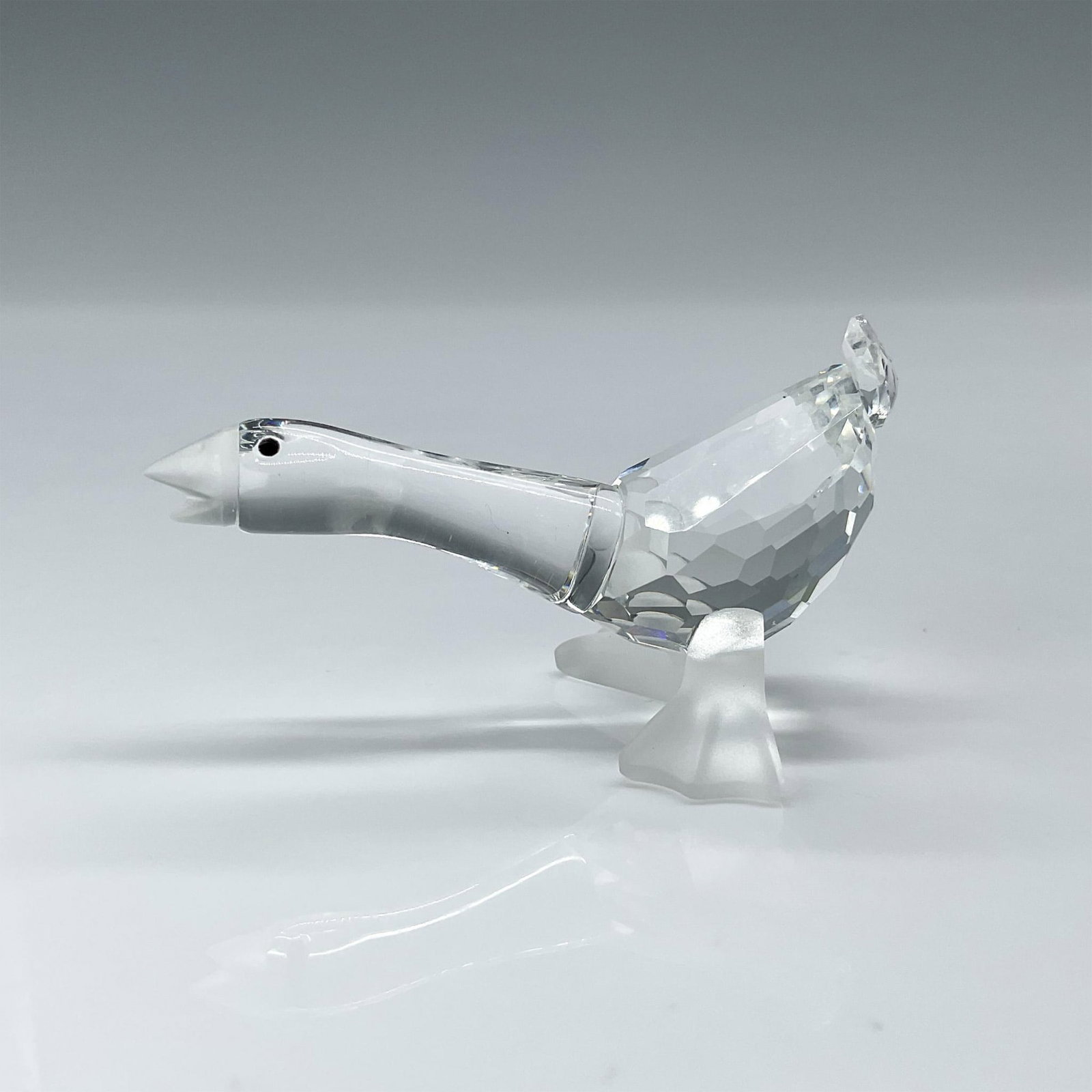 Swarovski Silver Crystal Figurine, Goose Harry: A clear faceted goose with black eyes. Frosted beak and feet. Swarovski mark. This item has its original box: 2.5"H x 3.25" dia. Dimensions: 2"L x 1.25"W x 1.25"H Manufacturer: Swarovski Country of Or