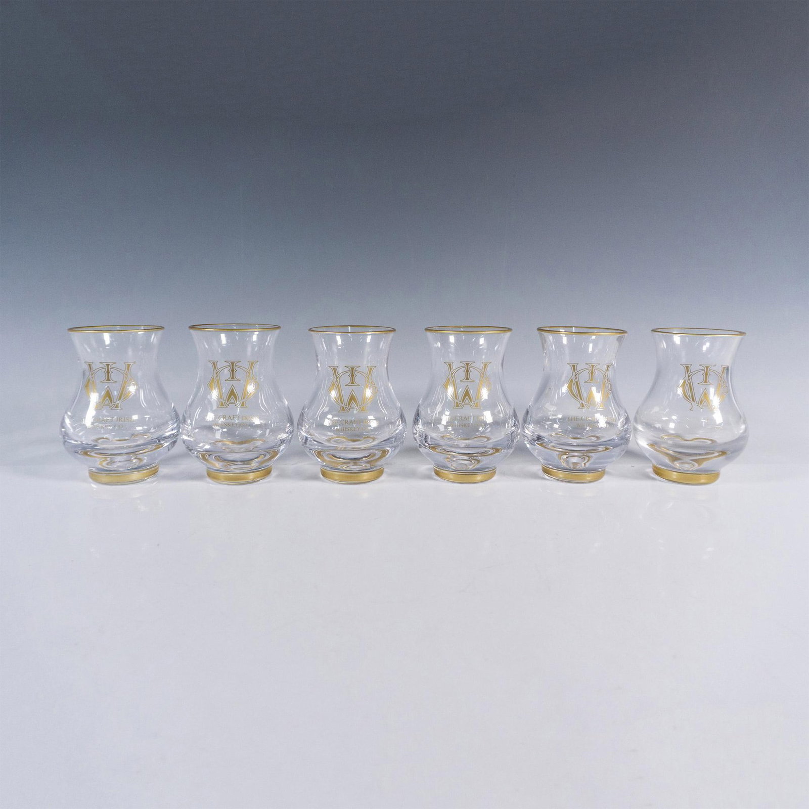 7pc The Craft Irish Whiskey Co. Erimon Glass Set: An exquisite ensemble from The Craft Irish Whiskey Co., embellished with their distinguished logo. This collection showcases 6 Erimon whiskey tasting glasses and a sleek cigar cutter, promising a refi