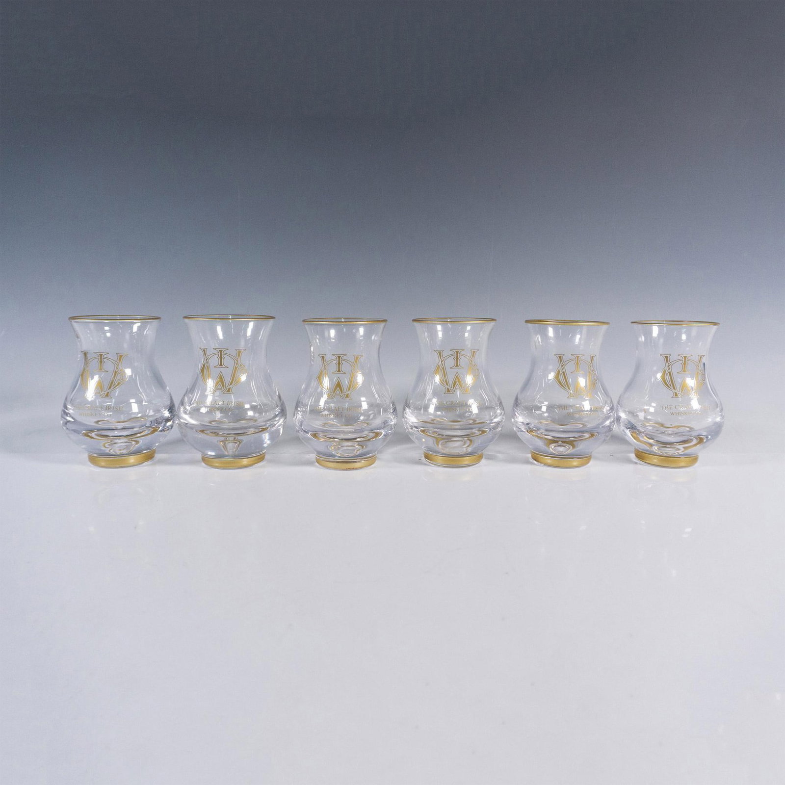 7pc The Craft Irish Whiskey Co. Erimon Glass Set: The Craft Irish Whiskey Co. presents an elegant set adorned with their signature logo. The collection features six Erimon whiskey tasting glasses and a sophisticated cigar cutter, offering a premium w