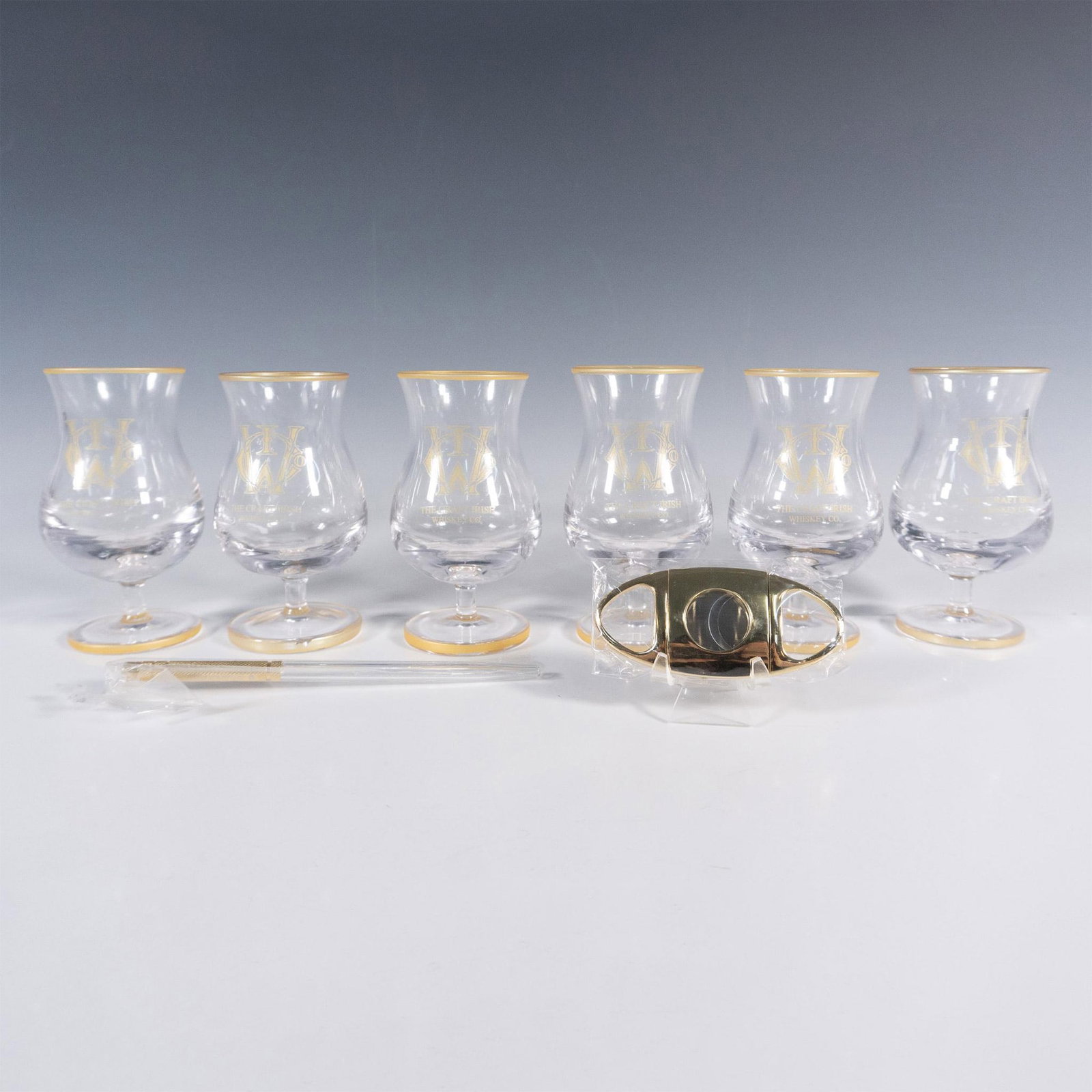 8pc The Craft Irish Whiskey Co. Finn Glass Set: This distinguished collection by The Craft Irish Whiskey Co. proudly showcases their logo and includes 6 Finn whiskey tasting glasses, an elegant pipette, and a sleek cigar cutter, ensuring an elevate