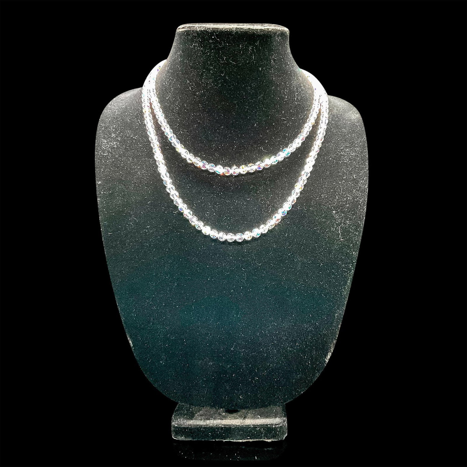 2pc Crystal Lariat Necklaces: Pair of crystal-beaded lariat necklaces. Gold-tone chain with round clear crystal beads and Monet mark impressed to lobster claw clasp. Iridescent crystal bead necklace with X brand marked to clasp. L