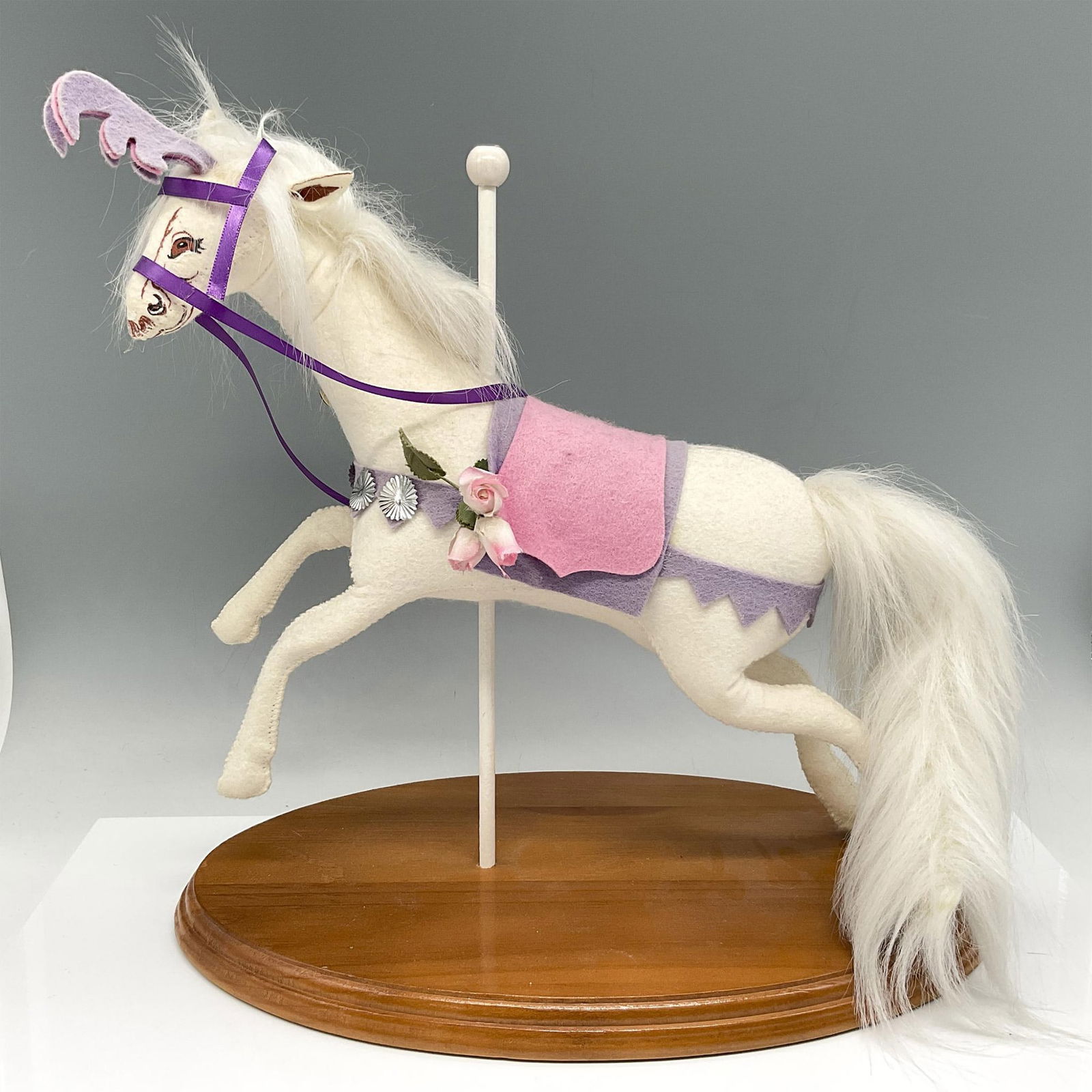 Vintage Collectible Annalee Dolls, Carousel Unicorn: Handmade, designed and painted felt horse adorned in pink and lavender saddle and ribbons that matches his horn. Hand painted face, white main and tail. Horse is set on wooden oval base. Annalee tag.