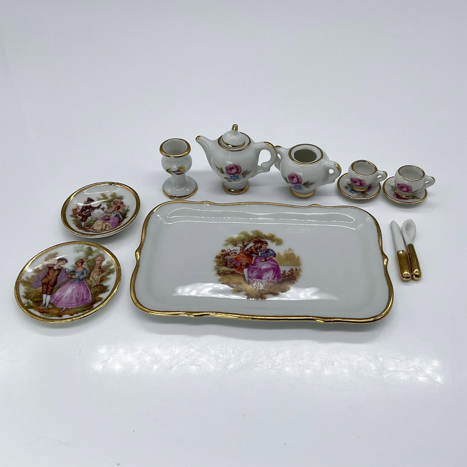 12pc SA Limoges Fine China Dollhouse Miniature Tea Set: These pretty Limoges porcelain pieces are all hand-decorated. The set includes a dainty dollhouse tea service with a tray, featuring a teapot with lid, two plates, two cups and saucers, a sugar caddy,