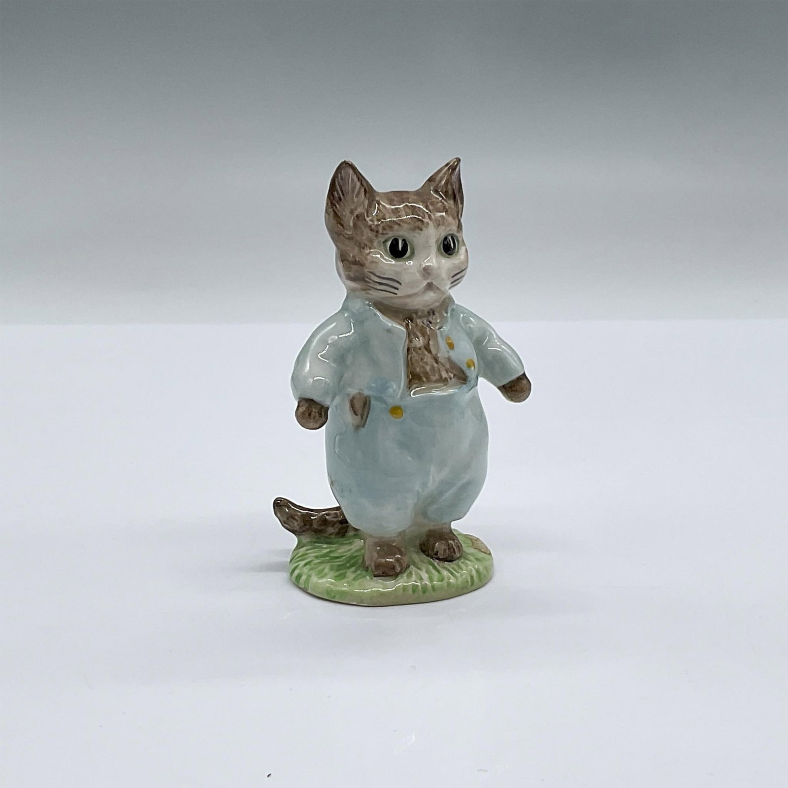 Beswick Beatrix Potter Figurine, Tom Kitten: Adorable kitten character modeled in soft blue clothes. Beswick Beatrix Potter backstamp. Issued: 20th c. Dimensions: 1.75''L x 2''W x 3.5''H Manufacturer: Beswick Country of Origin: England