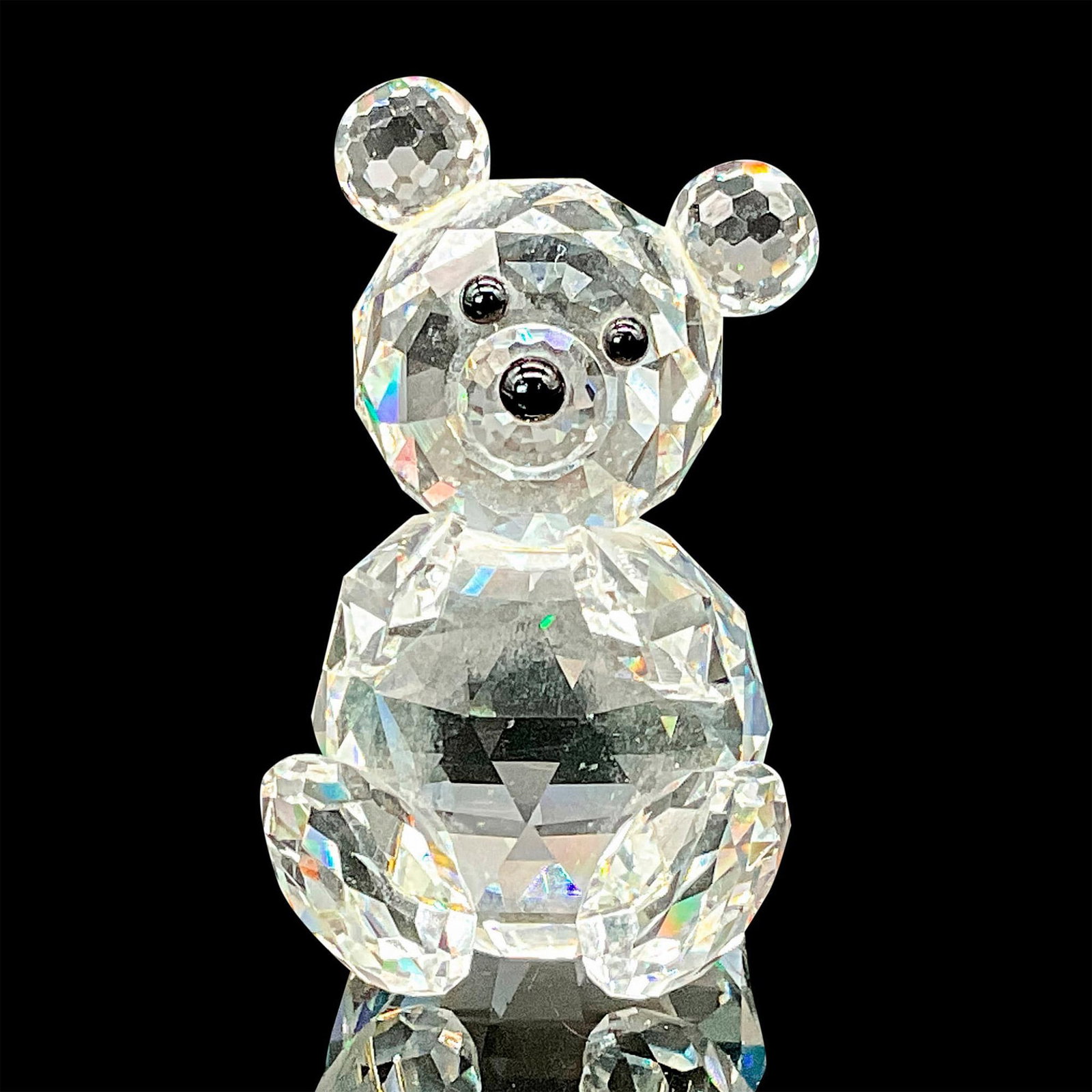 Swarovski Silver Crystal Figurine,: This Swarovski Silver Crystal teddy bear can be found with head tilted in either direction and is made of clear facetted crystal with black nose and eyes. Item comes with original box measuring 4"H x 
