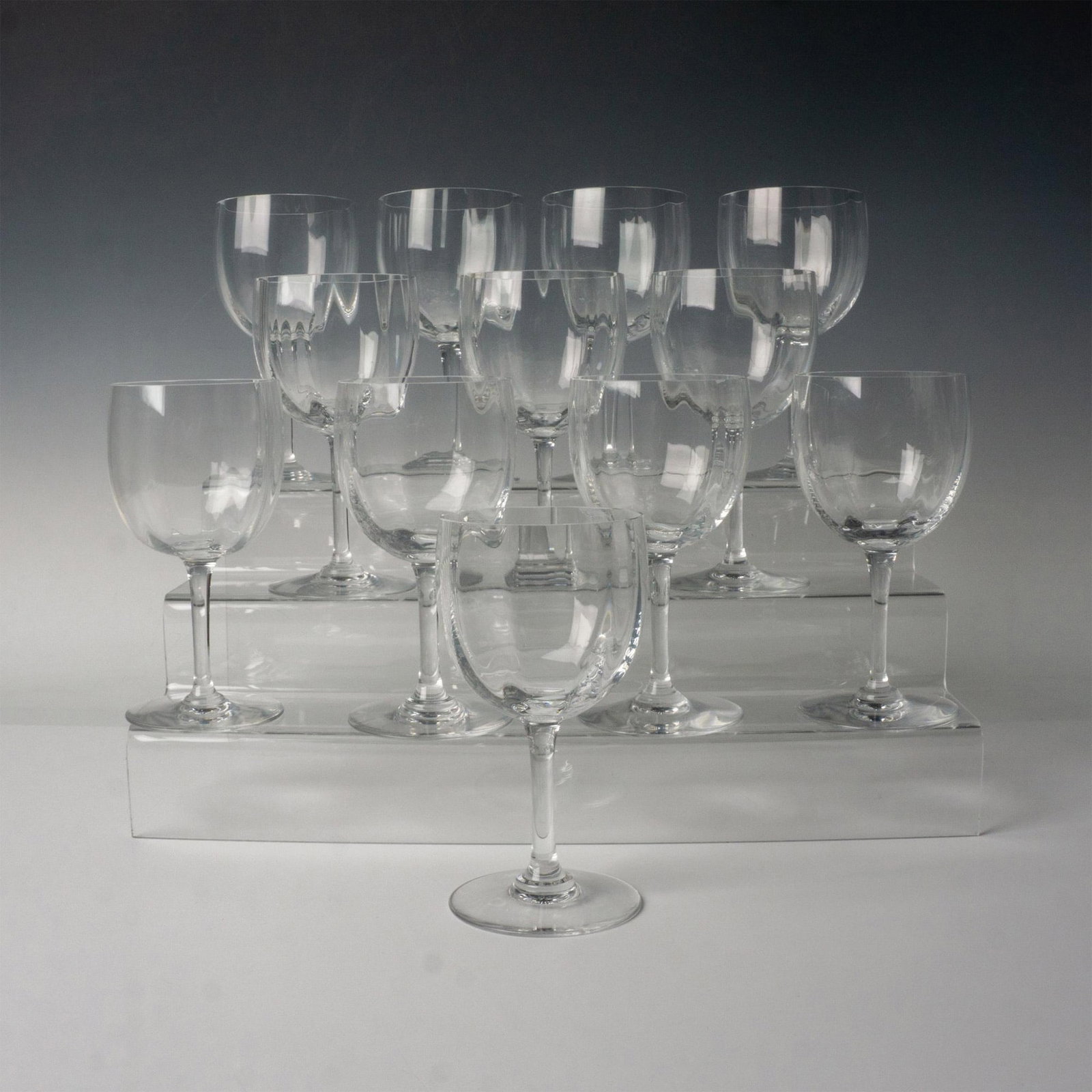 12pc Baccarat Crystal Wine Glasses, Montaigne: Twelve clear crystal stemmed crystal glasses with a pillowed wave pattern on the inner bowl. Baccarat backstamp. Dimensions: 6.5"H x 3.25" dia Manufacturer: Baccarat Country of Origin: France