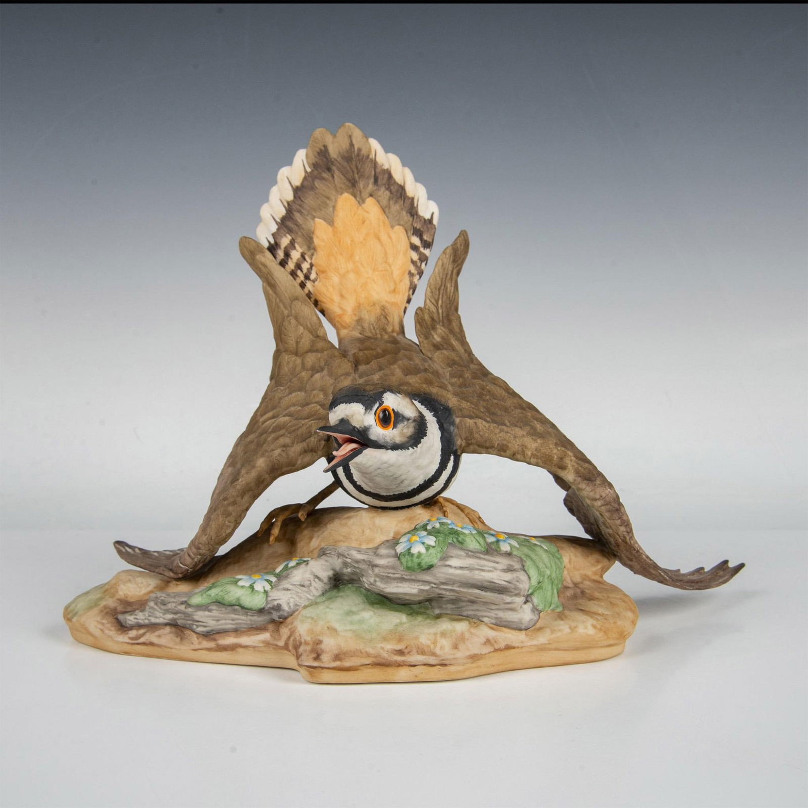 Boehm Limited Edition Sculpture, Male Killdeer 473G: Naturalistic hand painted and hand crafter figure of a male plover crouched close to the ground. Boehm markings. Issued: 20th century Dimensions: 12.25"L x 6.75"W x 8.75"H Manufacturer: Boehm Country
