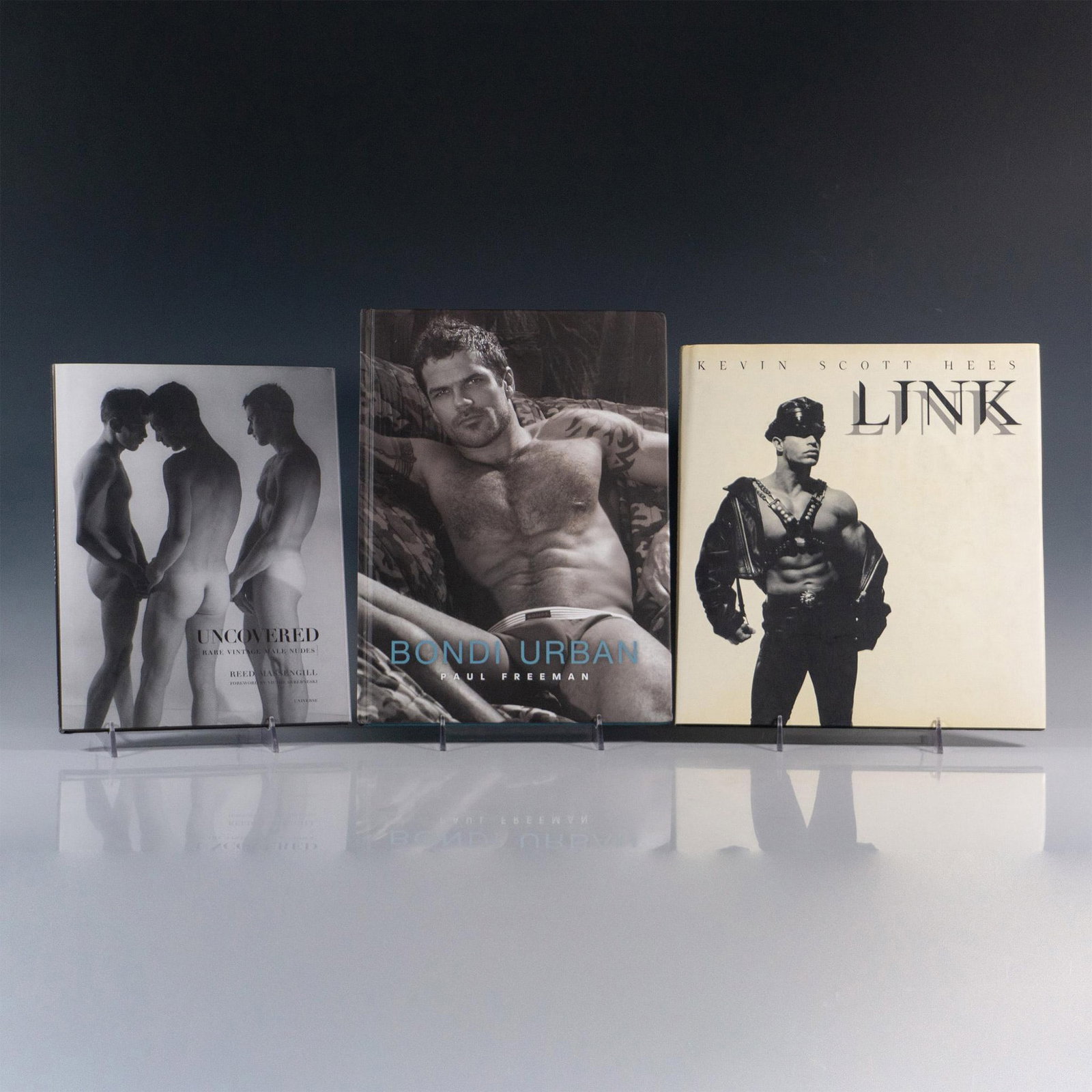 3 Books of Erotic Male Art Photography: A collection of black and white, sepia and colored photography books featuring nude male models in intense and artistic settings. Titles include Uncovered (Reed Messingill, 2009); Bondi Urban (Paul Fr