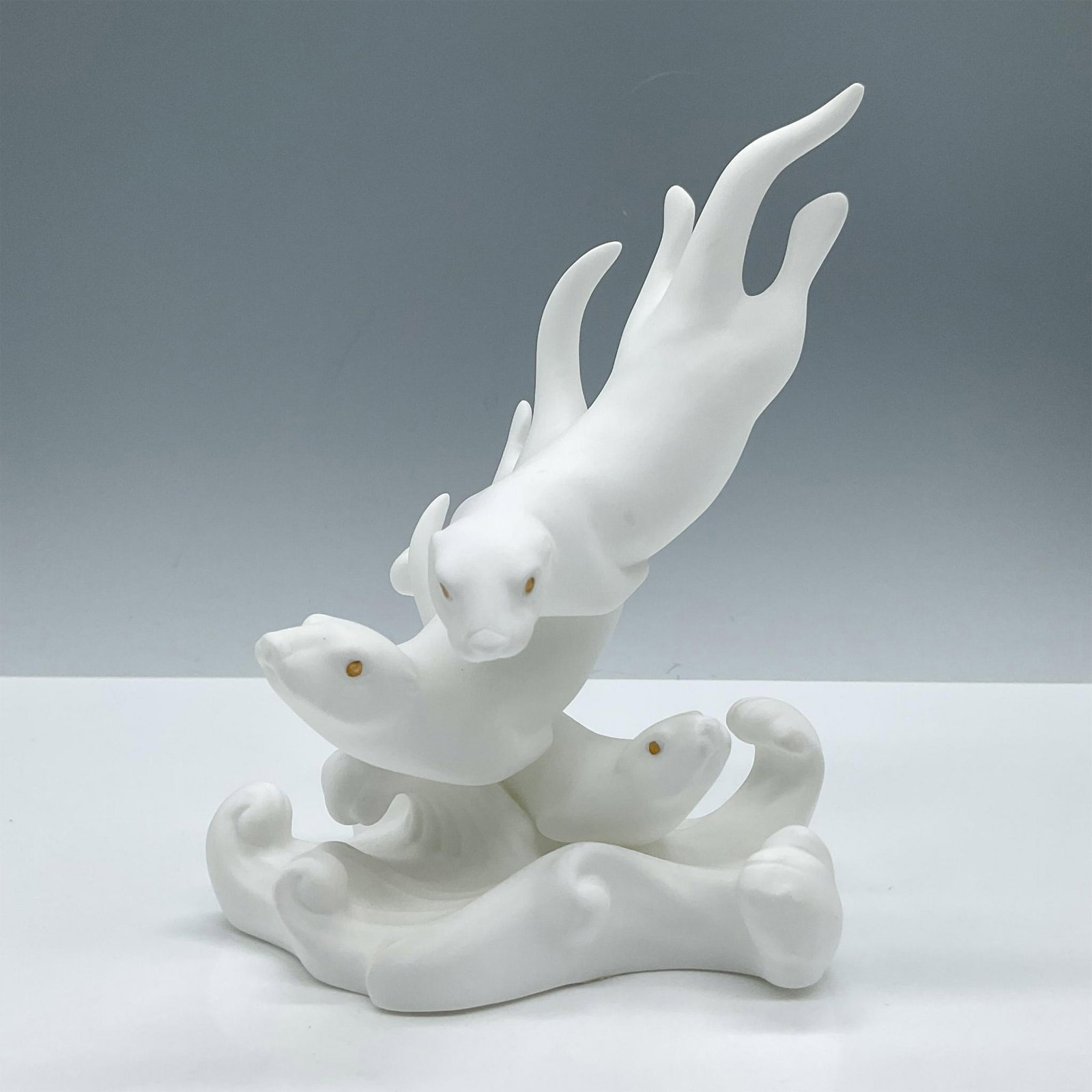 Lenox Fine Bone China Figurine, Otter Escapade: Part of the Sea Animal collection. Depicts three playful otters in white matte and gold eyes. Lenox backstamp. Issued: 1993 Dimensions: 4.25''L x 4.5''W x 6.5''H Manufacturer: Lenox