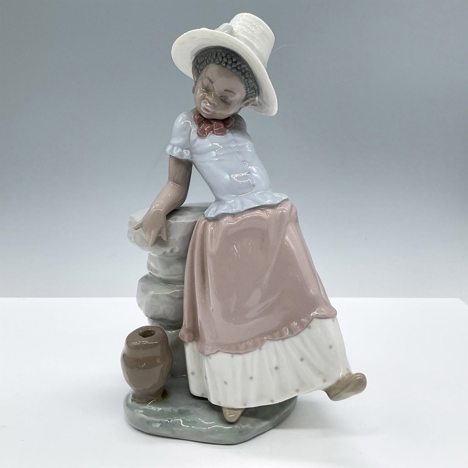 A Steppin' Time 1005158 - Lladro Porcelain Figurine: Glossy finish; Lladro backstamp. Artist: Jose Roig Issued: 1982 - 1998 Dimensions: 9"H x 5"W Manufacturer: Lladro Country of Origin: Spain