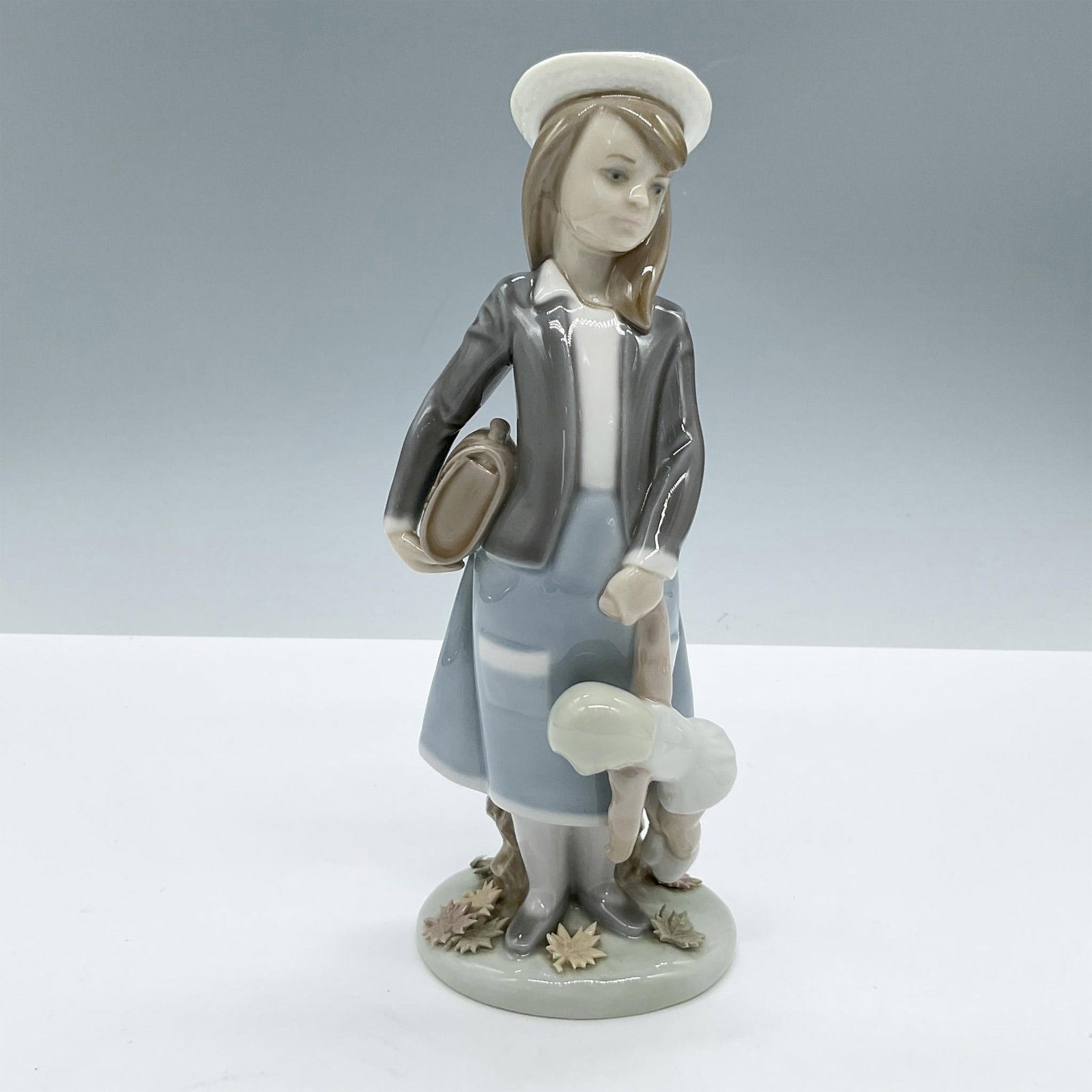 Autumn 1005218 - Lladro Porcelain Figurine: Glossy finish; Lladro backstamp. Artist: Juan Huerta Issued: 1984 - 1999 Dimensions: 8.25"H x 3.25"W Manufacturer: Lladro Country of Origin: Spain