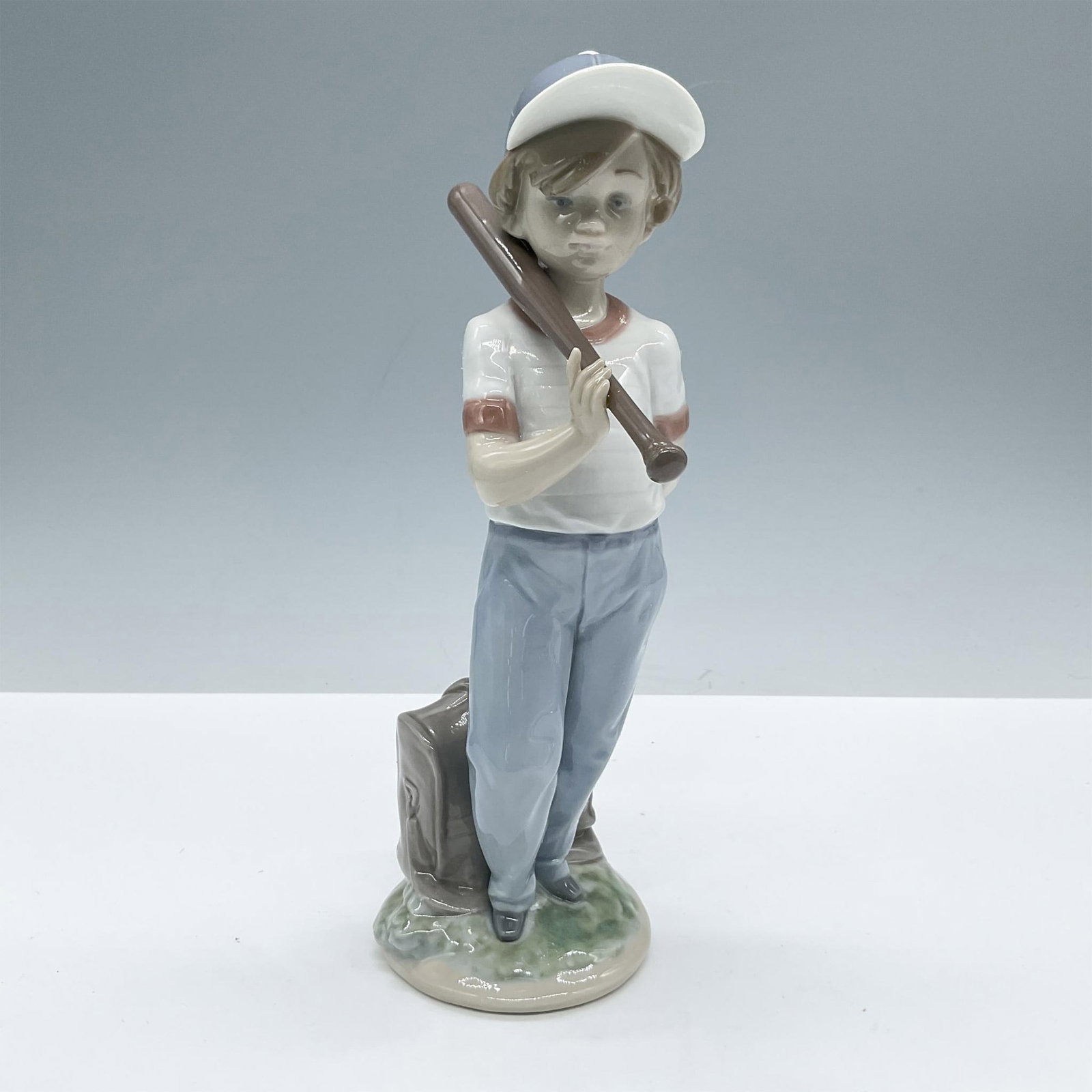 Can I Play ? 1007610 - Lladro Porcelain Figurine: Glossy finish; Features a boy about to play baseball. From the Collectors Society edition of 1990. Includes the original box, dimensions: 5.5''L x 10.5''W x 5''H. Artist: Antonio Ramos Issued: 1990 - 