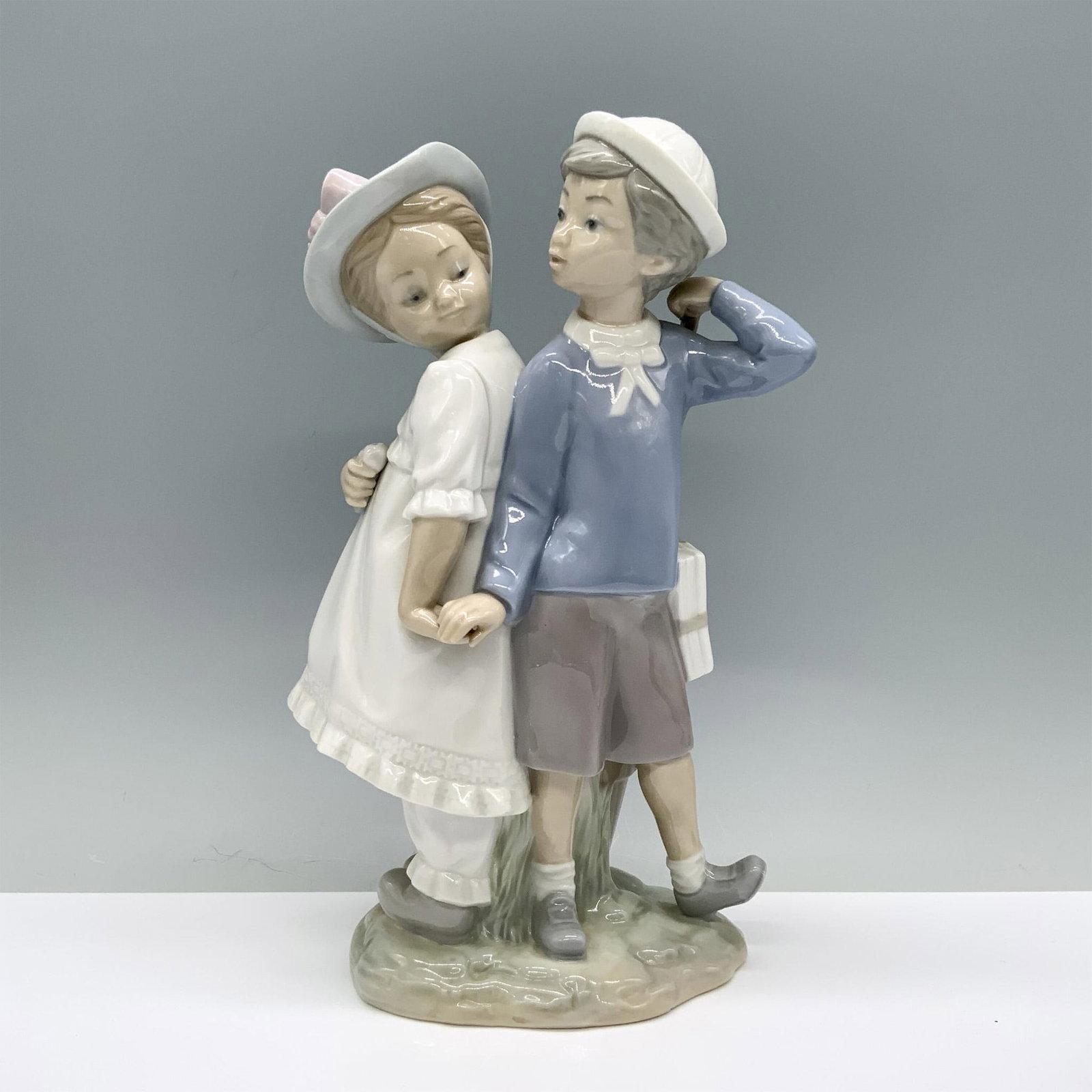 Puppy Love 1001127 - Lladro Porcelain Figurine: Glossy finish; Lladro backstamp. Artist: Vicente Martinez Issued: 1971 - 1996 Dimensions: 10.5"H Manufacturer: Lladro Country of Origin: Spain