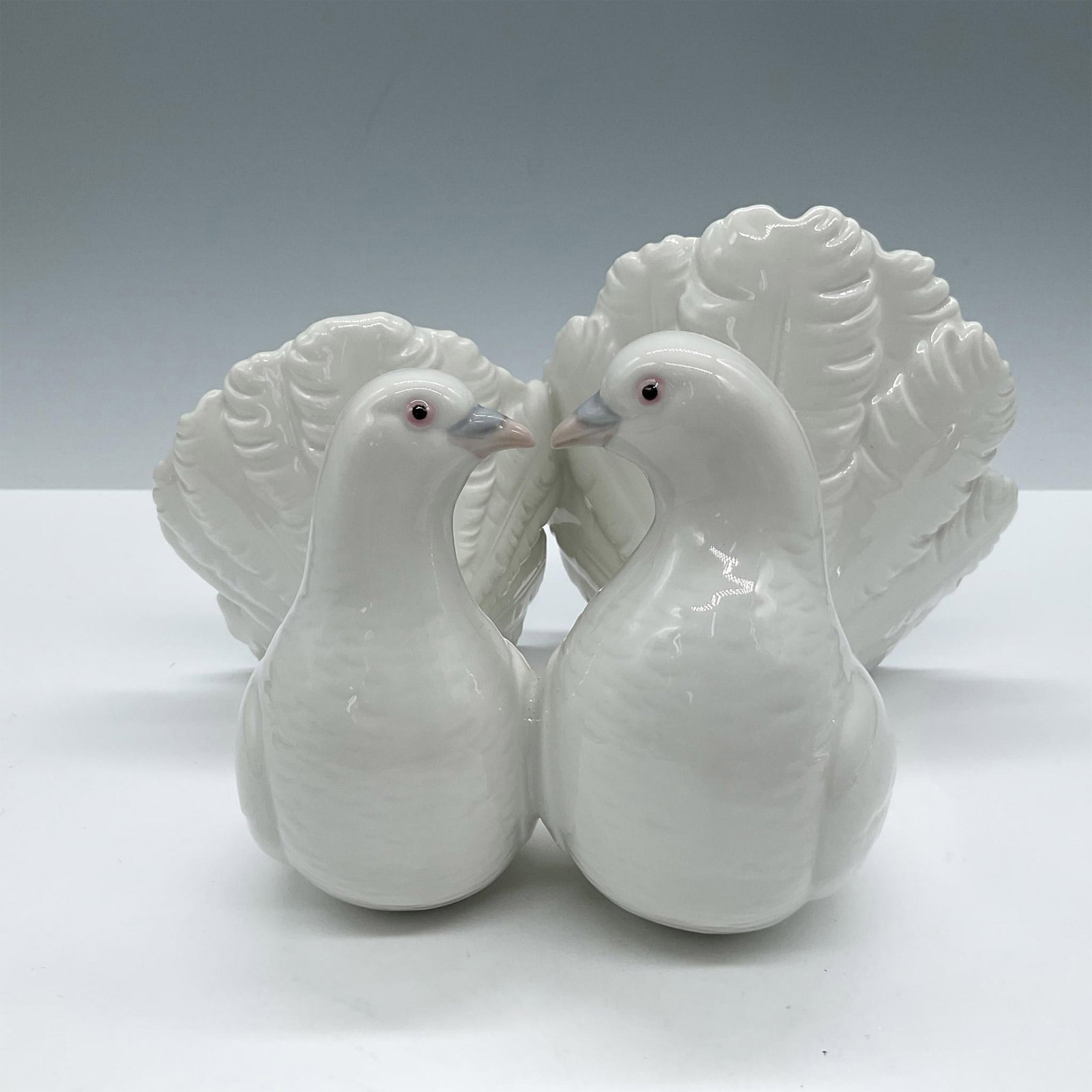 Couple Of Doves 1001169 - Lladro Porcelain Figurine: Glossy finish; Lladro backstamp. Artist: Antonio Ballester Issued: 1971 Dimensions: 4.75"H x 7.5"W Manufacturer: Lladro Country of Origin: Spain