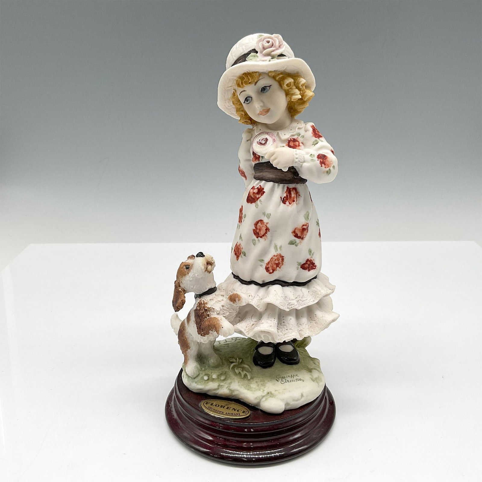 Florence Giuseppe Armani Figurine, It's Mine: This is a Society Members Figurine - Little girl in floral print dress, hat holding her lollipop away from her dog. Florence Giuseppe Armani and Capodimonte backstamp. 136C. Artist: D.T.L. Issued: 199