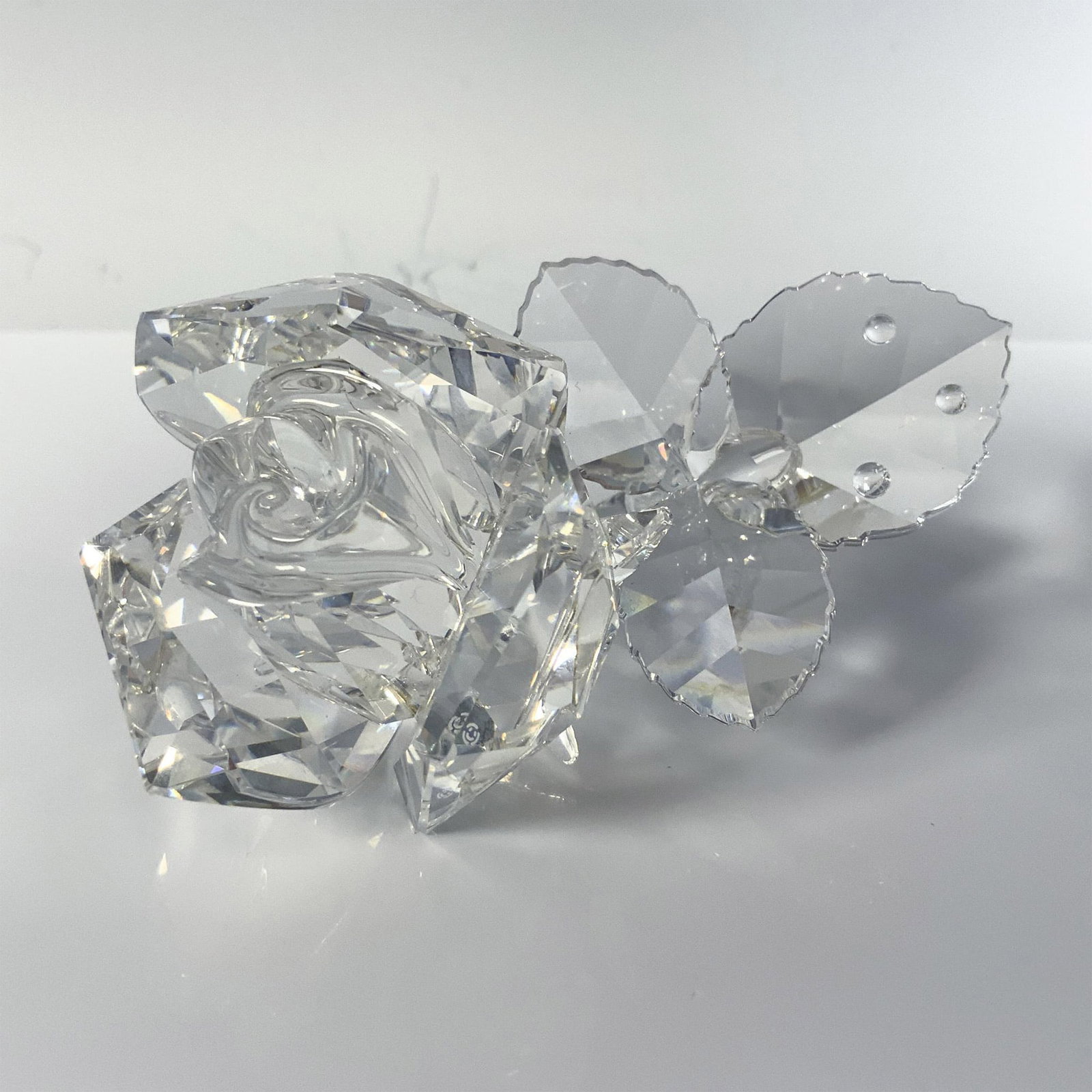 Swarovski Silver Crystal Figurine, Rose Blossom: Lovely, crystal flower is part of the Secret Garden theme group. To add to the delicate design crystal rhinestones have been added to the leaves mimicking dew drops. Swarovski backstamp. 890289. This 