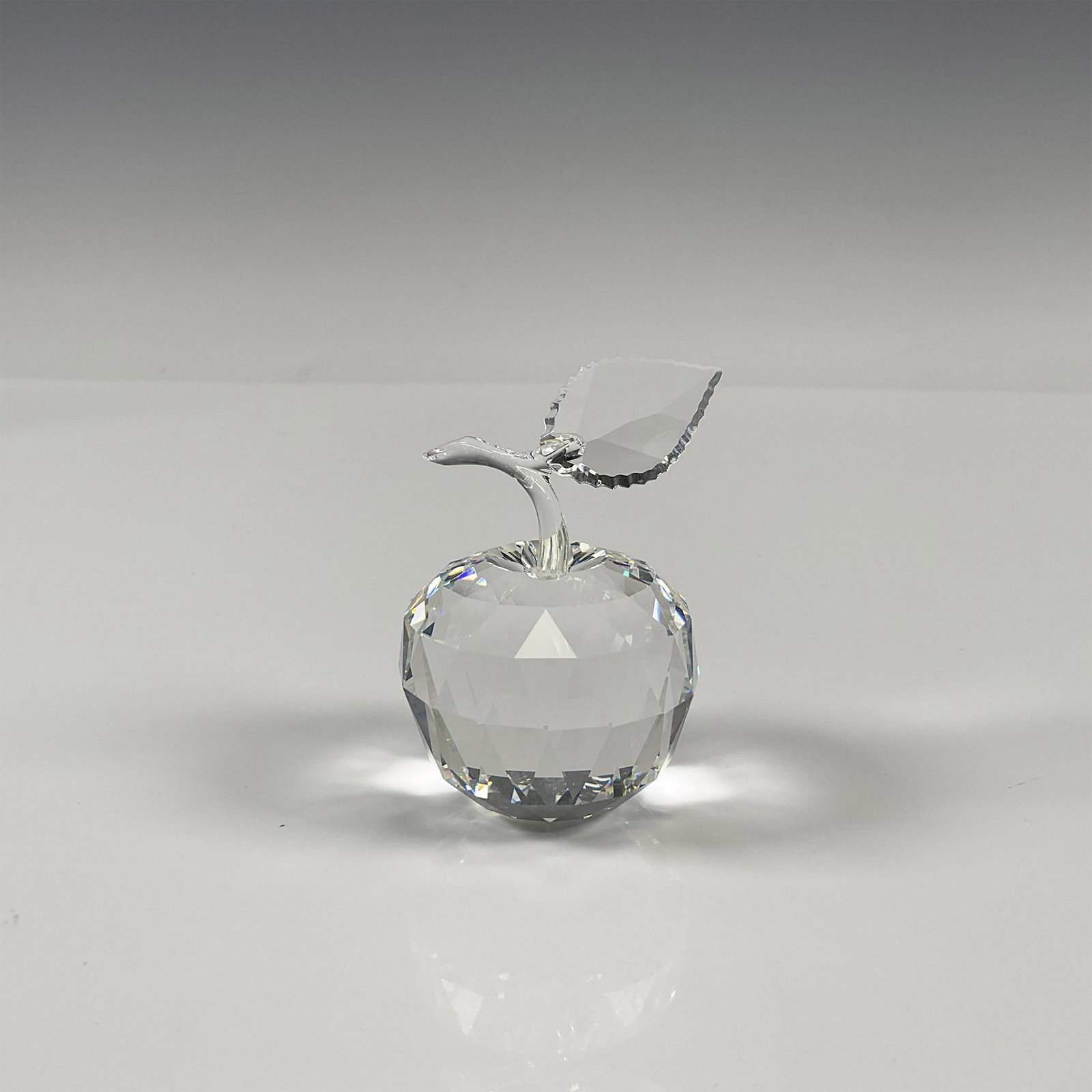 Swarovski Silver Crystal Figurine, Apple: Crystal figure was part of the Sparkling Fruit series. Made from clear crystal, the logo can be found on the bottom of the apple. Swarovski backstamp. 160796. This item has its original box 4"H x 5" d
