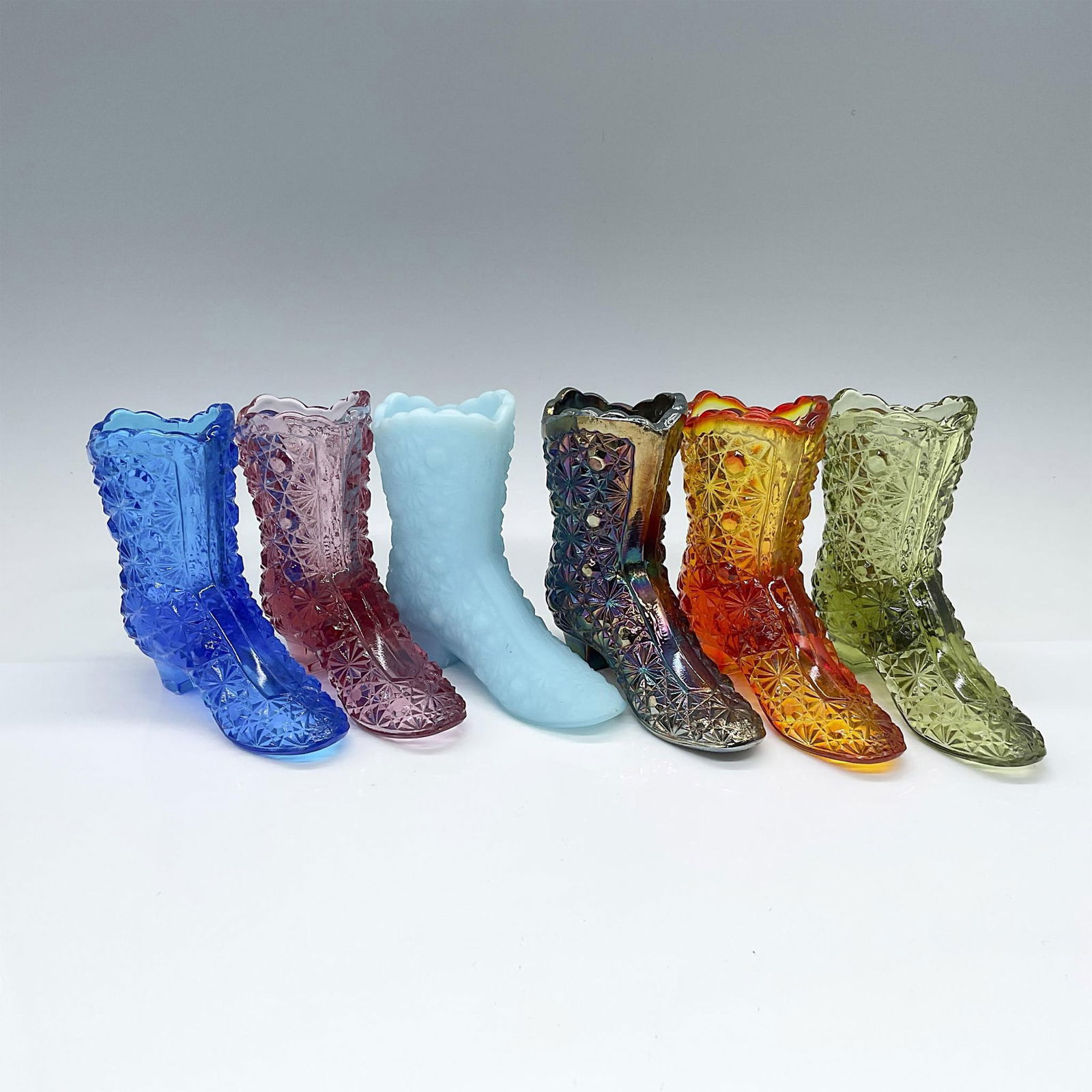 6pc Vintage Fenton Color Glass Boots: This vibrant rainbow collection features an array of colors, including blue satin, brilliant blue, pink, orange, green, and iridescent purple carnival glass. Issued: 20th century Dimensions: 4.5"L x 1