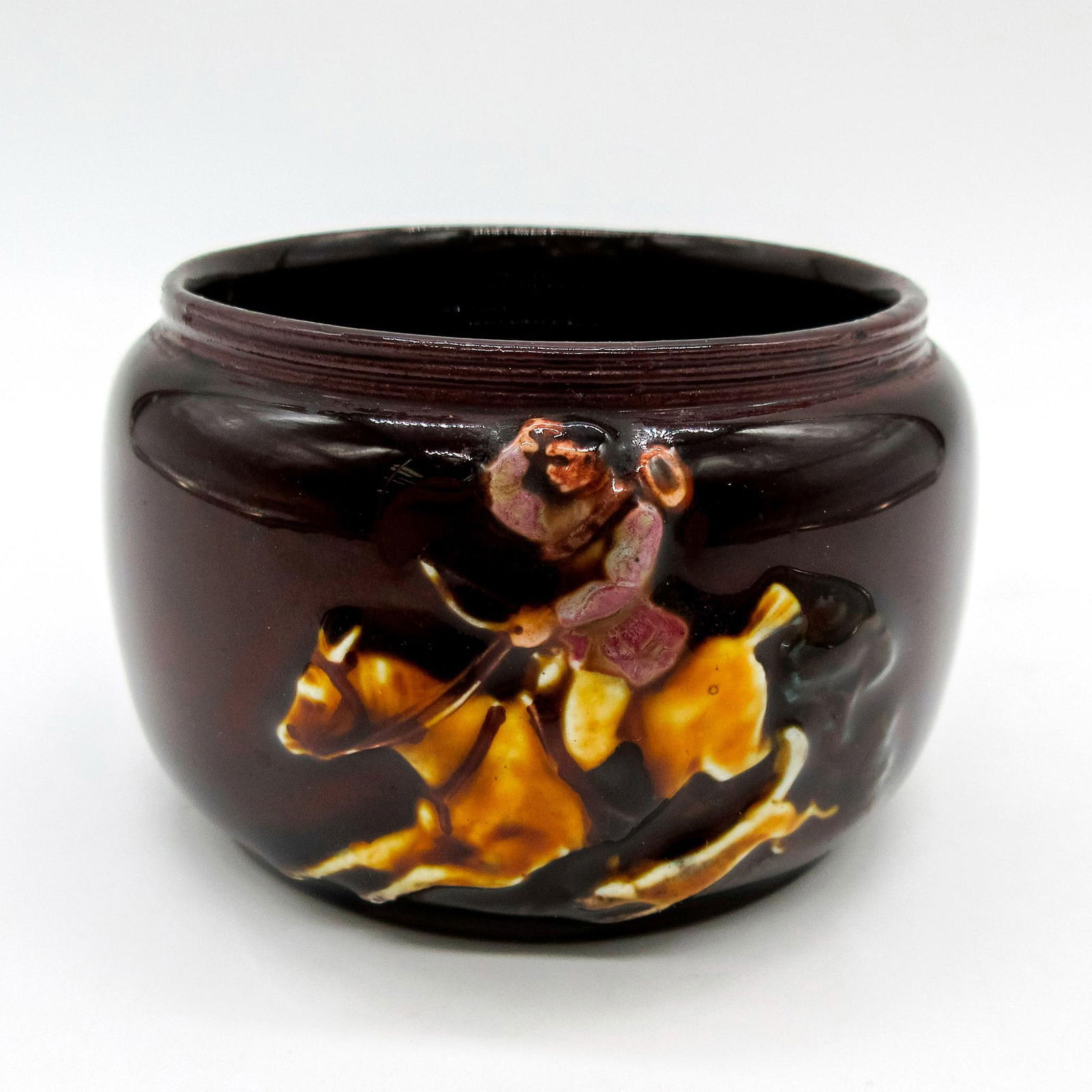 Royal Doulton Hunting Kingsware Salt Cellar: Dark brown glaze; reliefs of a hunter riding a horse and hounds on the other side. Royal Doulton backstamp. Dimensions: 2H" x 3" Diameter Manufacturer: Royal Doulton Country of Origin: England