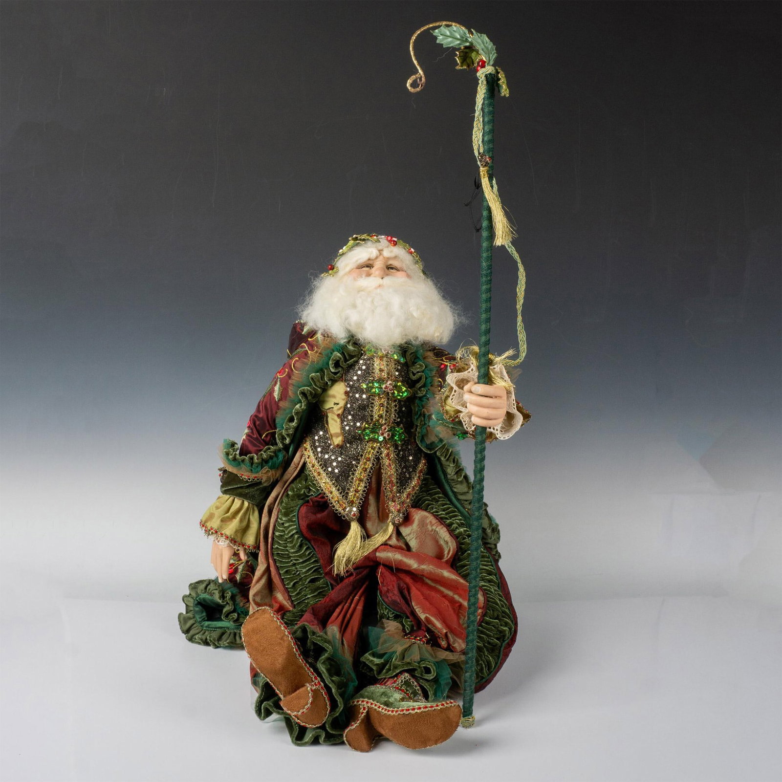 Bergdorf Goodman Father Christmas with Staff: Large and beautifully appointed Father Christmas decked out in maroon, green, and gold cloak. His bejeweled vest has gold tassels and amazing detailing. Green staff with gold hook measures 30"H. Dimen
