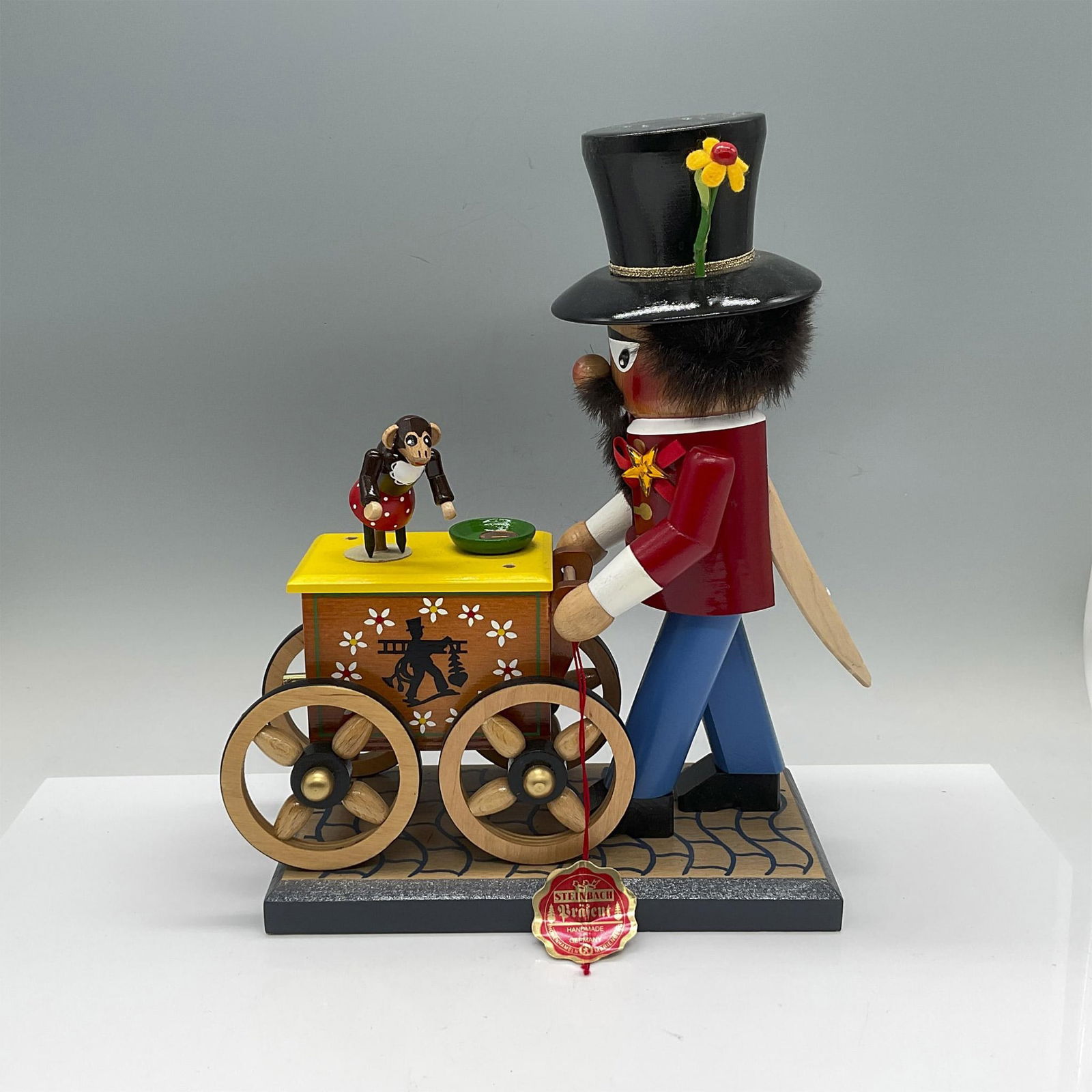 Vintage Steinbach German Musical Nutcracker, Organ Grinder: Handcrafted and hand painted tuneful nutcracker depicted as an organ grinder. Turn key on the front with pull off-and-on switch. When activated the monkey dances. Steinbach original tag and impressed