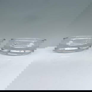 2pc Orrefors Crystal Candle holders, Pucks: A sleek pair of round clear candle holders, designed in the shape of pucks with a center hole for easy candle placement. Marked Orrefors. Orrefors manufacturing sticker. Artist: Lena Bergstrom Dimensi