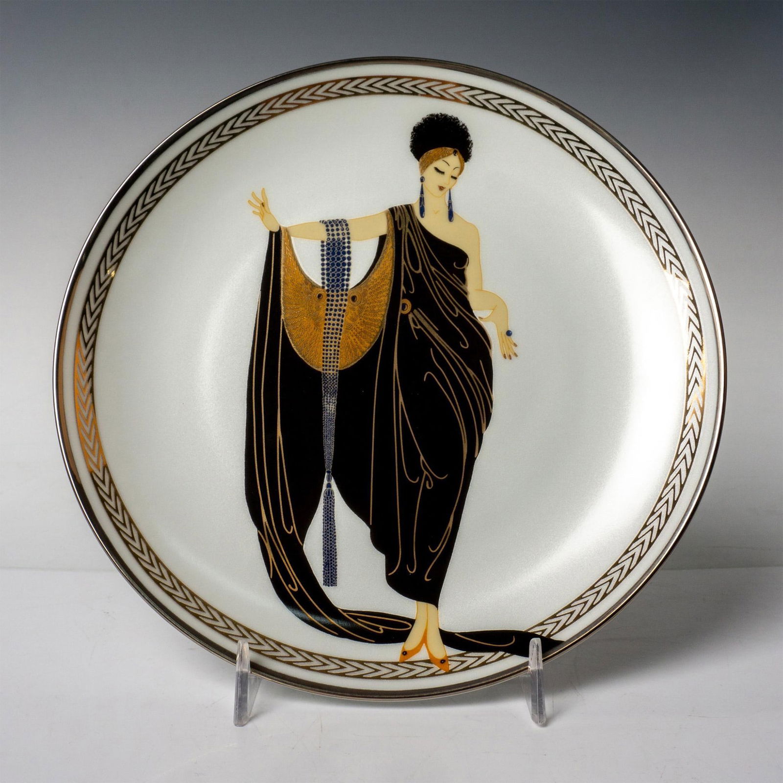 Franklin Mint House of Erte, Collector Plate, Glamour: Franklin Mint collector decorative porcelain plate bordered and hand-numbered with platinum for the House of Erte that depicts a personification of Glamour by Art Deco artist Erte. On verso: Glamour,