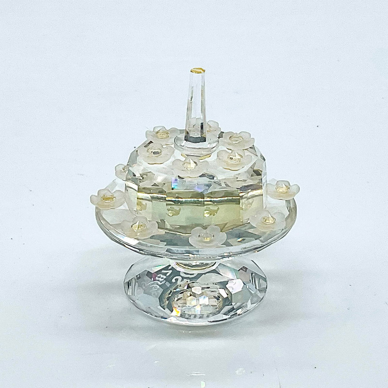 Swarovski Crystal Figurine, Birthday Cake: Multifaceted clear crystal birthday cake. Limited edition SCS birthday/anniversary cake was only available during 1992 to commemorate/celebrate the 5th anniversary of the SCS. A clear cake on a stand 