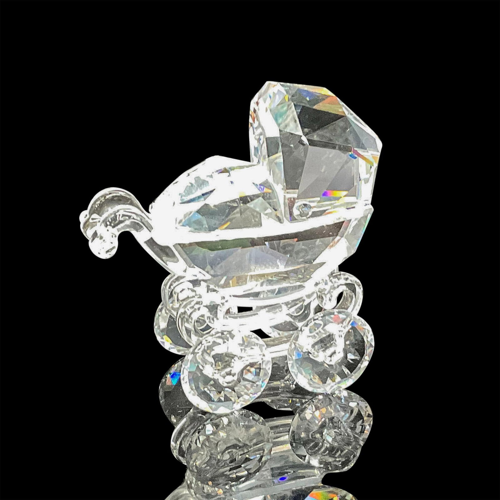 Swarovski Silver Crystal Figurine, Baby Carriage: Clear crystal detail representation of a buggy. Swarovski backstamp. 7473 000 005. This item has its original box: 3"H x 4"dia. Certificate of Authenticity included. Artist: Gabriel Stamey Issued: 20t