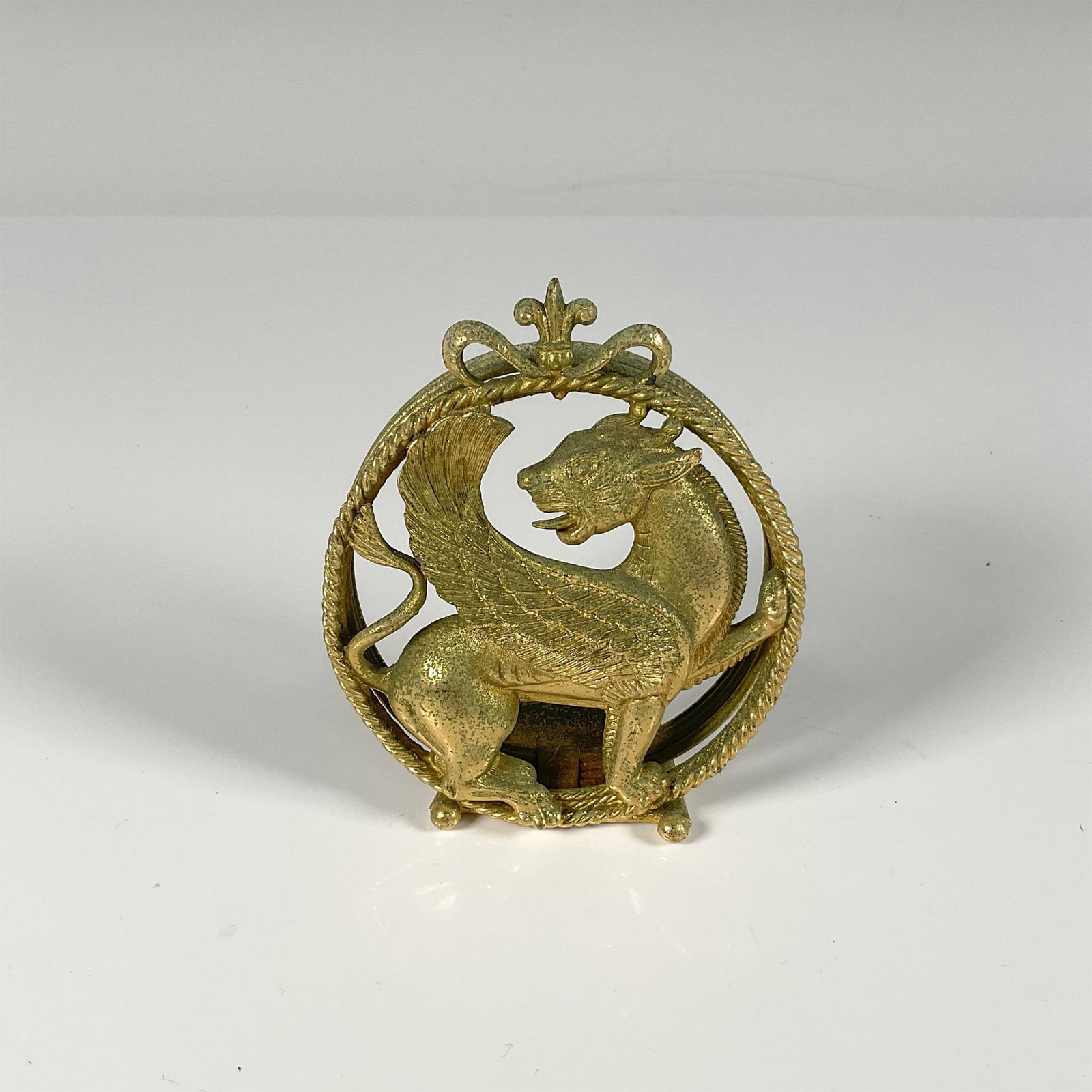 Florenza Gilt Brass Persian Griffin Card Holder: A beautiful metal craftsmanship of patina brass featuring a legendary creature in a Persian style. Florenza stamped on the back. Issued: 20th century Dimensions: 3.5"L x 2"W x 4"H Manufacturer: Floren