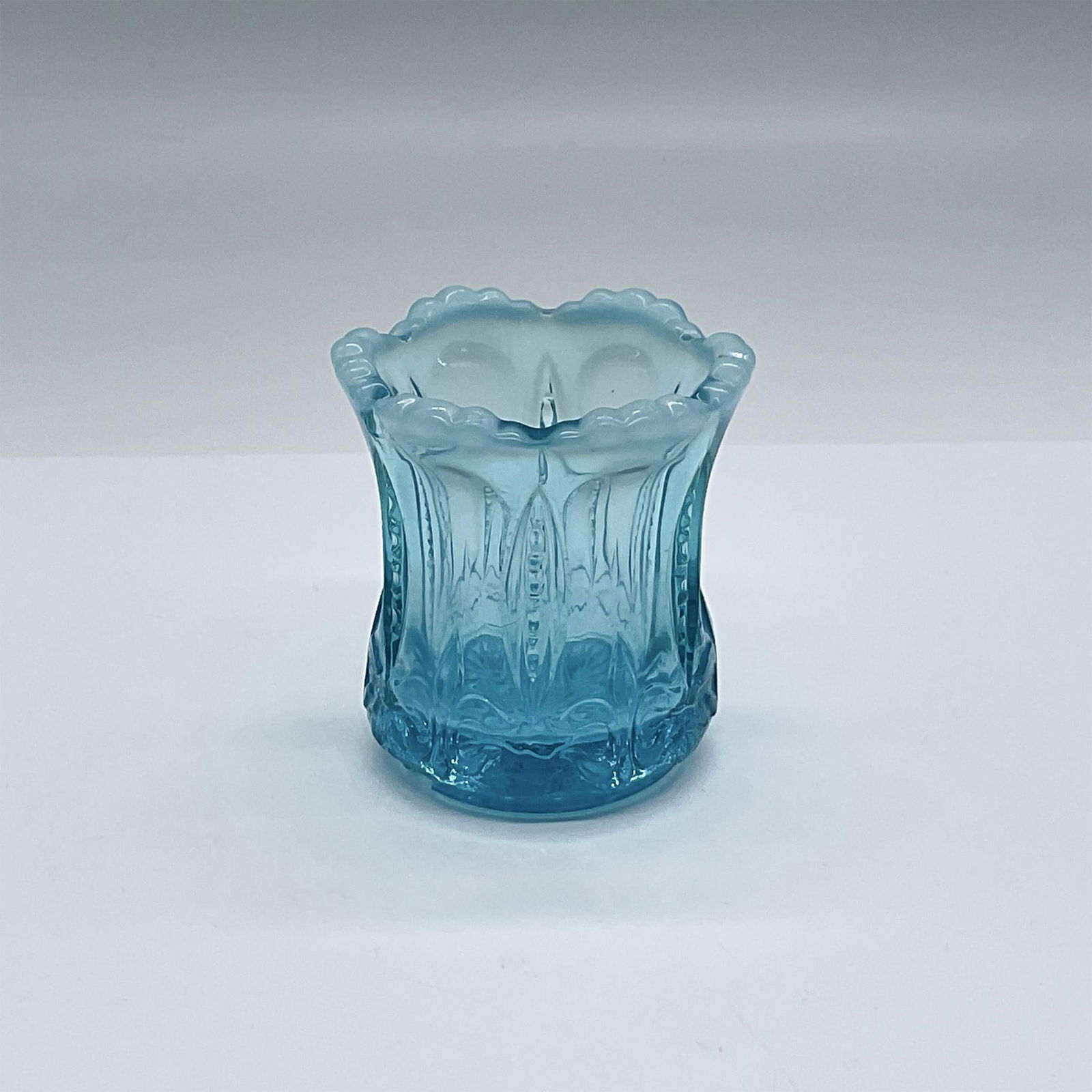 US Glass, Blue Glass Toothpick Holder: Pretty bright blue toothpick holder with milk glass at the top edge. Issued: 20th c. Dimensions: 2.25"dia. x 2.5"H Manufacturer: US Glass Country of Origin: USA