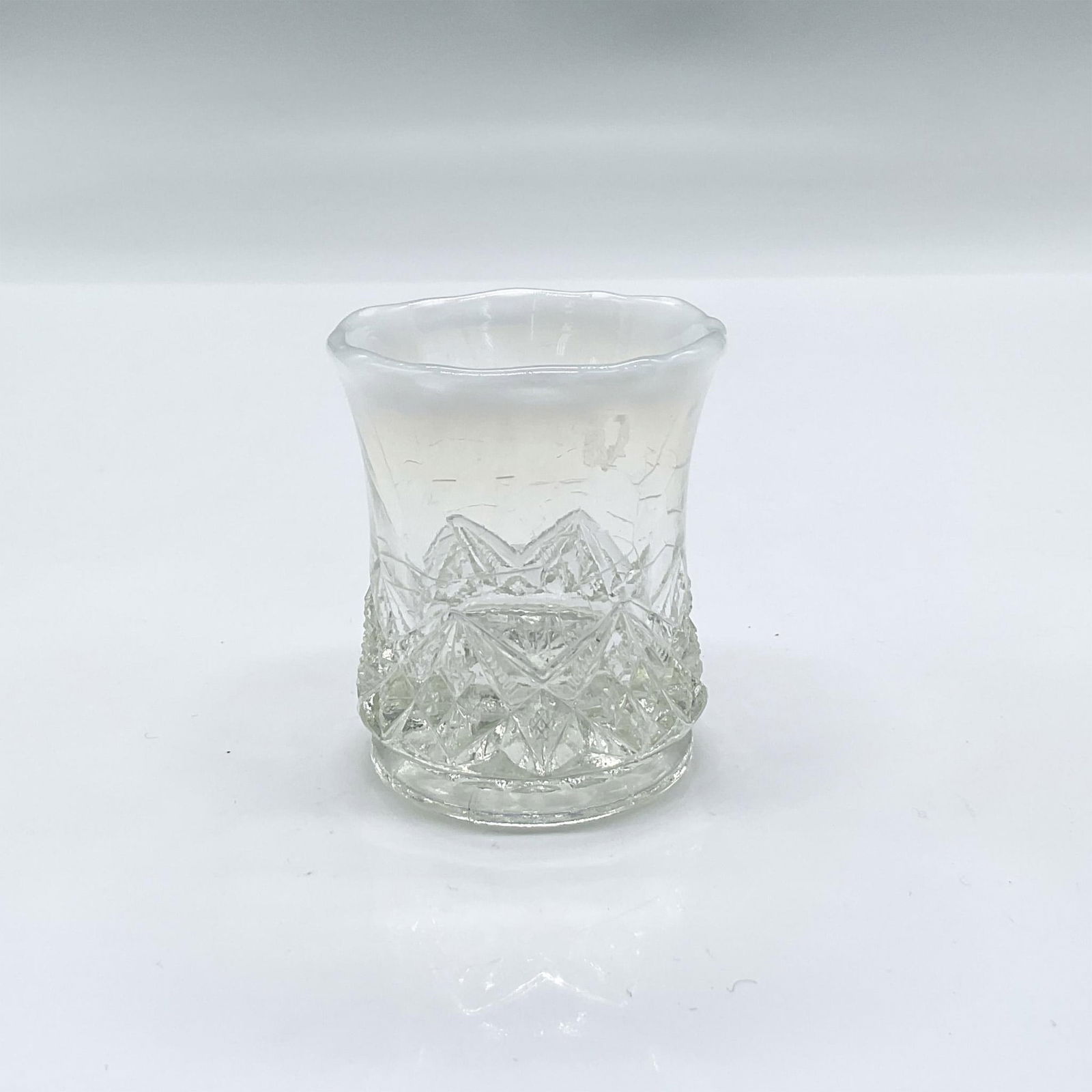 Vintage Glass Toothpick Holder, Iridescent Edge: Clear glass toothpick holder with iridescent opaque rim and engraved geometric design towards base. Dimensions: 2.5"H x 2" dia
