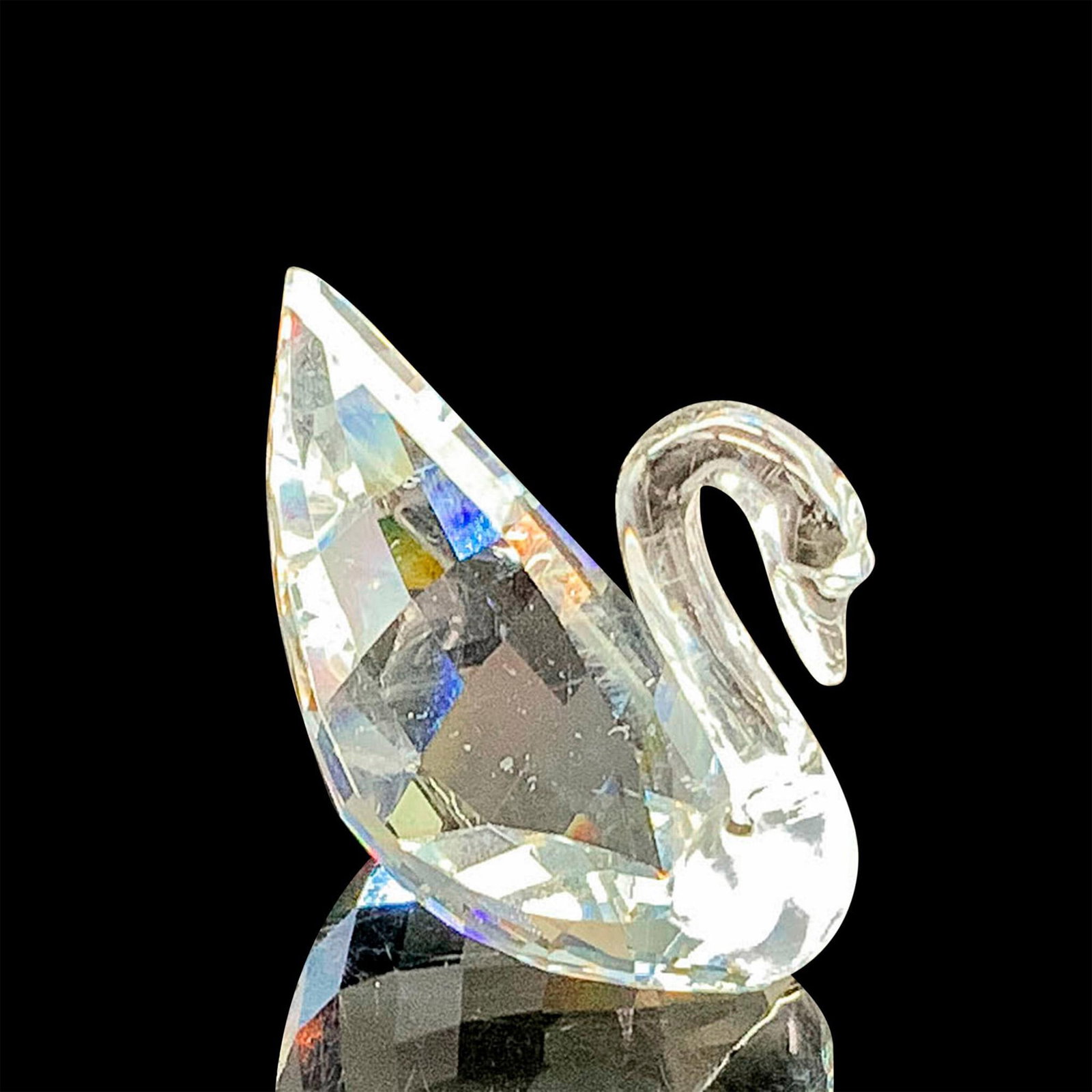 Swarovski Crystal Figurine, SCS Mini Swan: This figurine is made from clear faceted crystal. Swarovski acid mark on bottom. The box measures 2.5"dia. x 2.25"H. Dimensions: 1"L x 0.75"W x 1"H Manufacturer: Swarovski Country of Origin: Austria