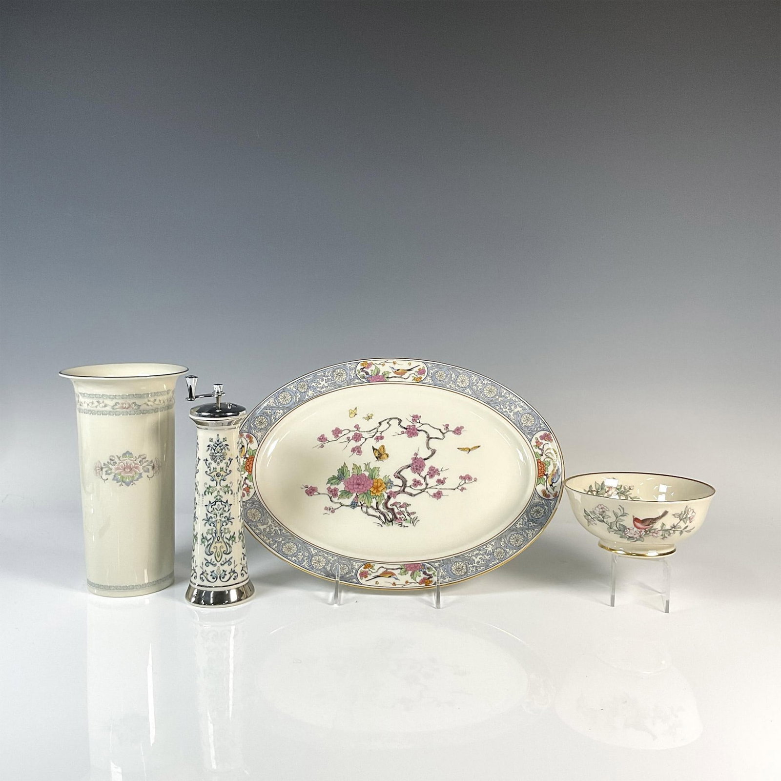 4pc Lenox Porcelain Serving Platter, Bowl, Vase and Grinder: Four cream colored porcelain serveware and decorative items. Ming oval serving platter with 24K gold rims and a colorful design of flowers, birds, flowers and butterfly 13.25"L x 9.75"W x 1"H. Small S