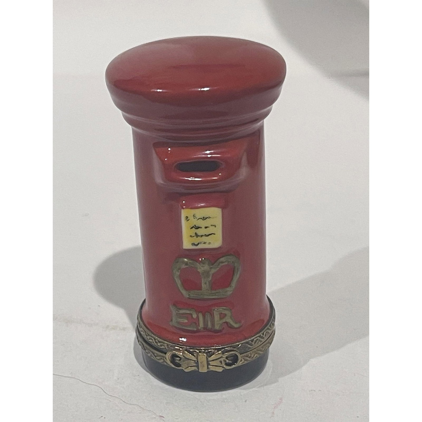 Limoges France Keepsake Box, Red English Mailbox: English Post Mailbox Keepsake Box is a vibrant red hand-painted design with black and 24k gold accents. Gilded double loop closure at hinge opens to reveal two posted letters already inside. There is 