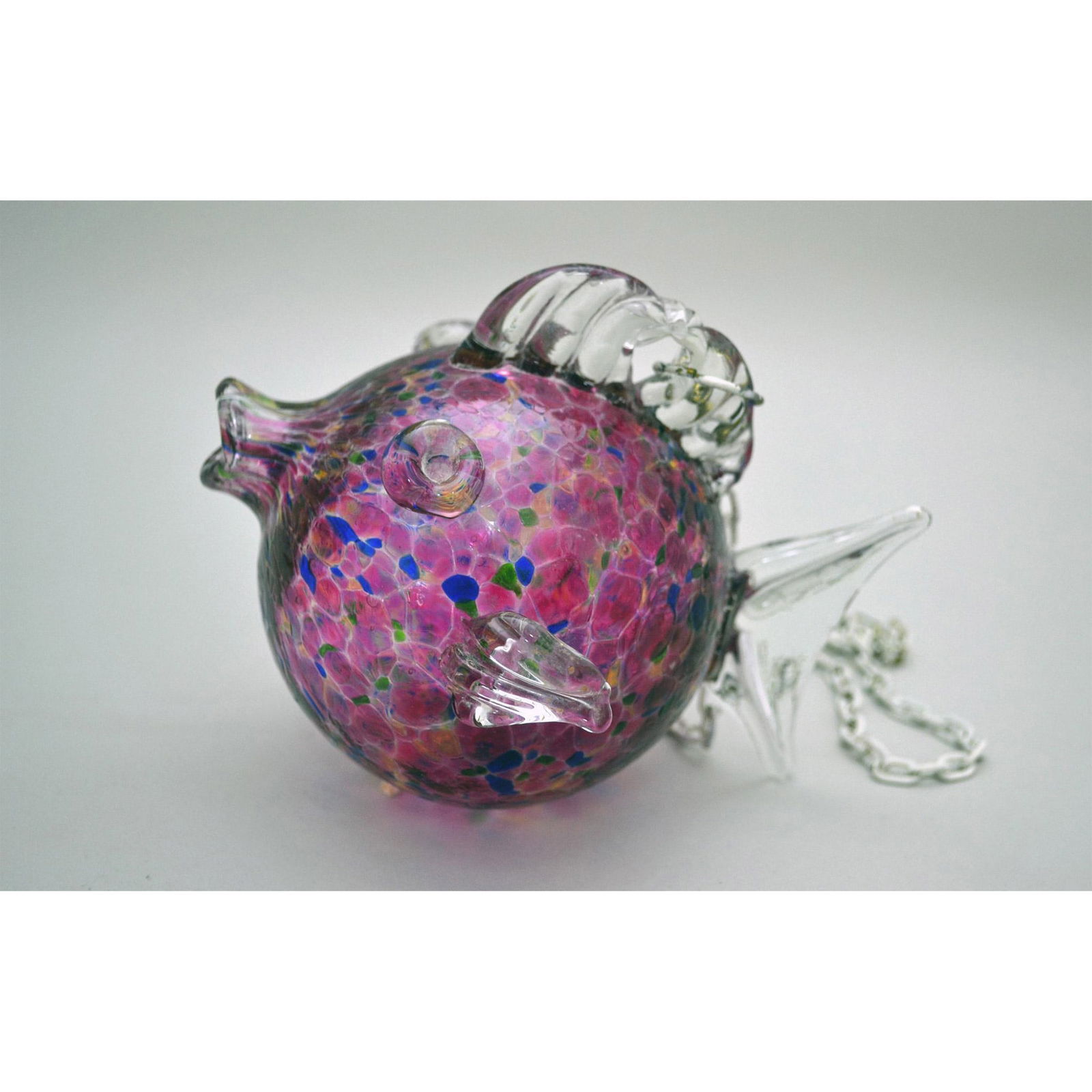 Ninart Art Glass Multi-Color Blow Fish: Ninart for BirdBrain, Hand Created, Hand Made, Mouth Blown Art Glass Blow Fish in Mulberry Ground with Blue and Green colorations surrounding the body of the fish. Handcrafted Art Glass. Chain attache