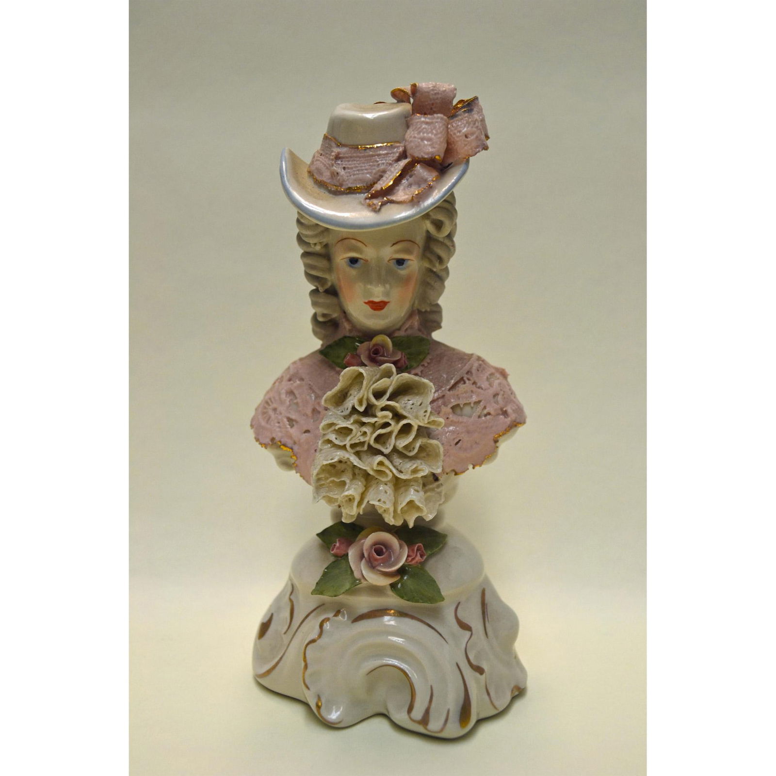 Cordey Porcelain Lady Bust In Lace W/Hat: Bisque Glazed Porcelain, hand created, hand painted by Bolesaw Cybis. Early and Rare featuring a Lady Figurine with Lace Applied. Pink Lace Bodice, with ivory Ruffle Lace, Hat with Pink Ribbon Lace, a