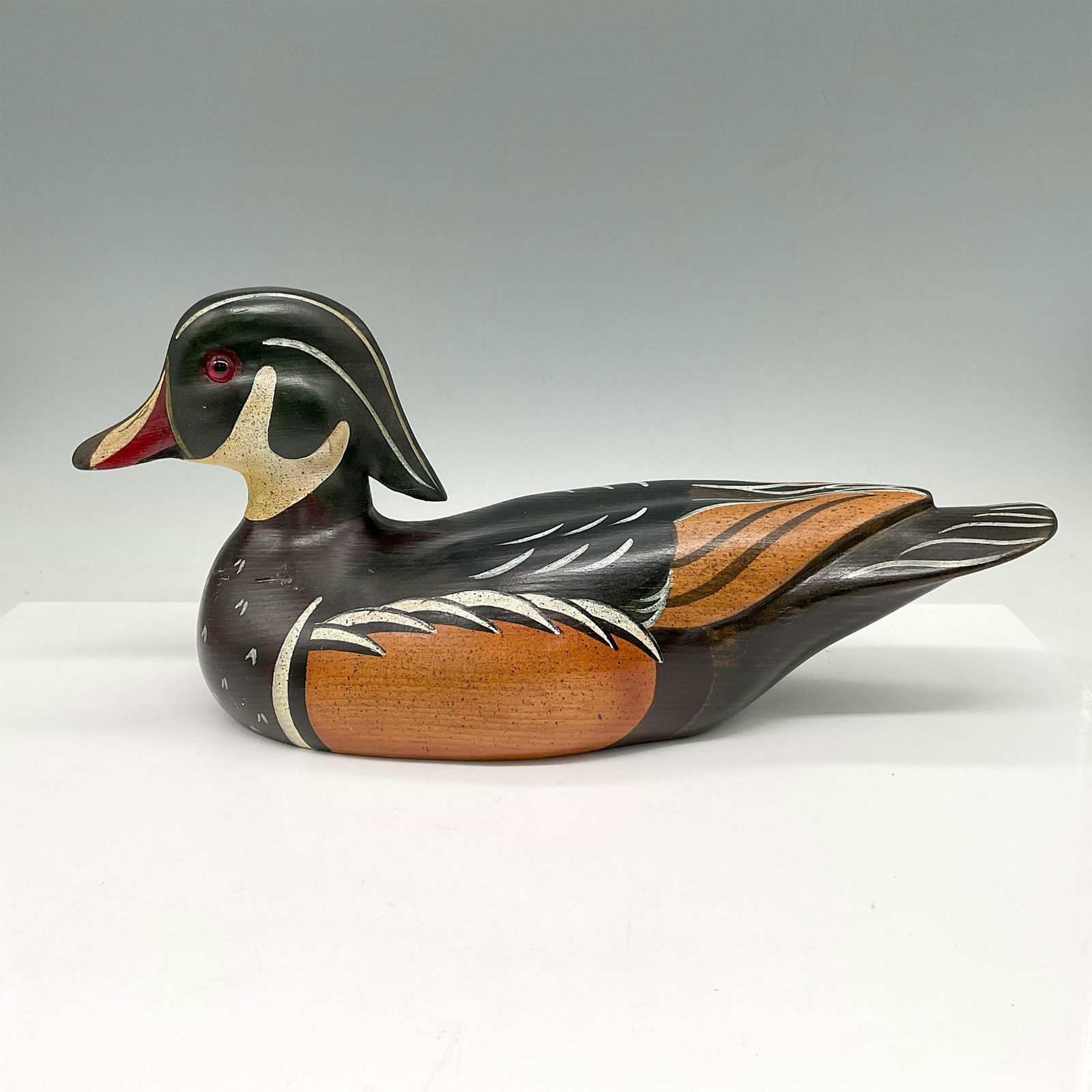 Bob May Hand Carved Wooden Duck, Drake: Wonderfully detailed bird colored in black, orange, red and brown with cream accents. Signed and dated by artist. Artist: Bob May Issued: 1986 Dimensions: 13.5"L x 5"W x 6.5"H Country of Origin: Unite