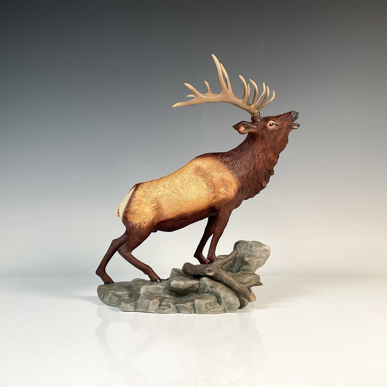 Porcelain Franklin Mint Elk Sculpture, The Challenger: A beautiful porcelain hand-painted figure of a majestic Elk titled The Challenger. Official issue of the National Wildlife Federation on its 50th Anniversary. Backstamp on base. Issued: 1986 Dimension
