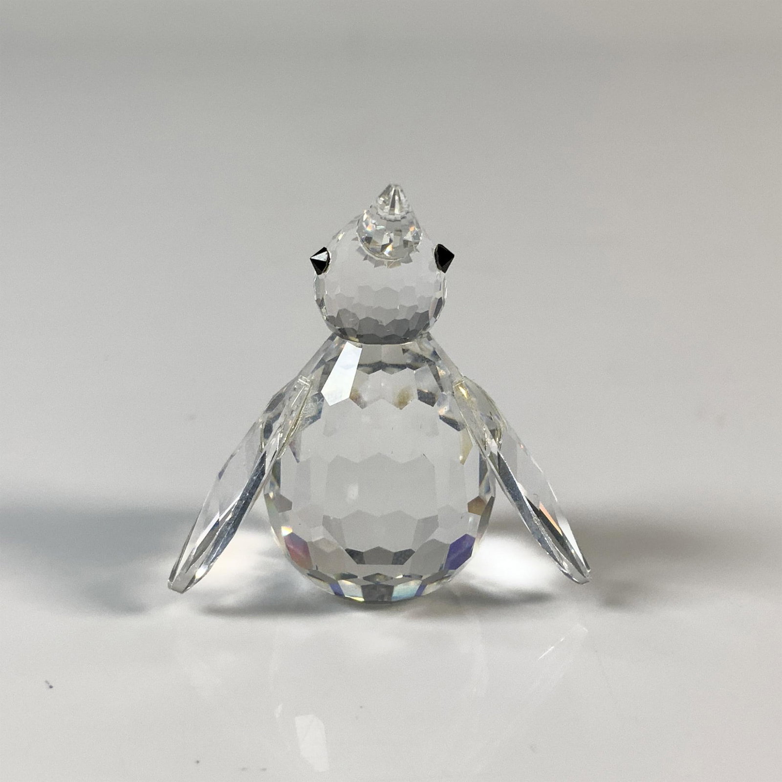Swarovski Silver Crystal Penguin Figurine, 7661 NR 33: This chill bird has a clear cut crystal body with black eyes. This item has its original box which measures 2.75"H x 2.5" dia. Acid etched Swarovski backstamp. Issued: 20th Century Dimensions: 0.75"L 