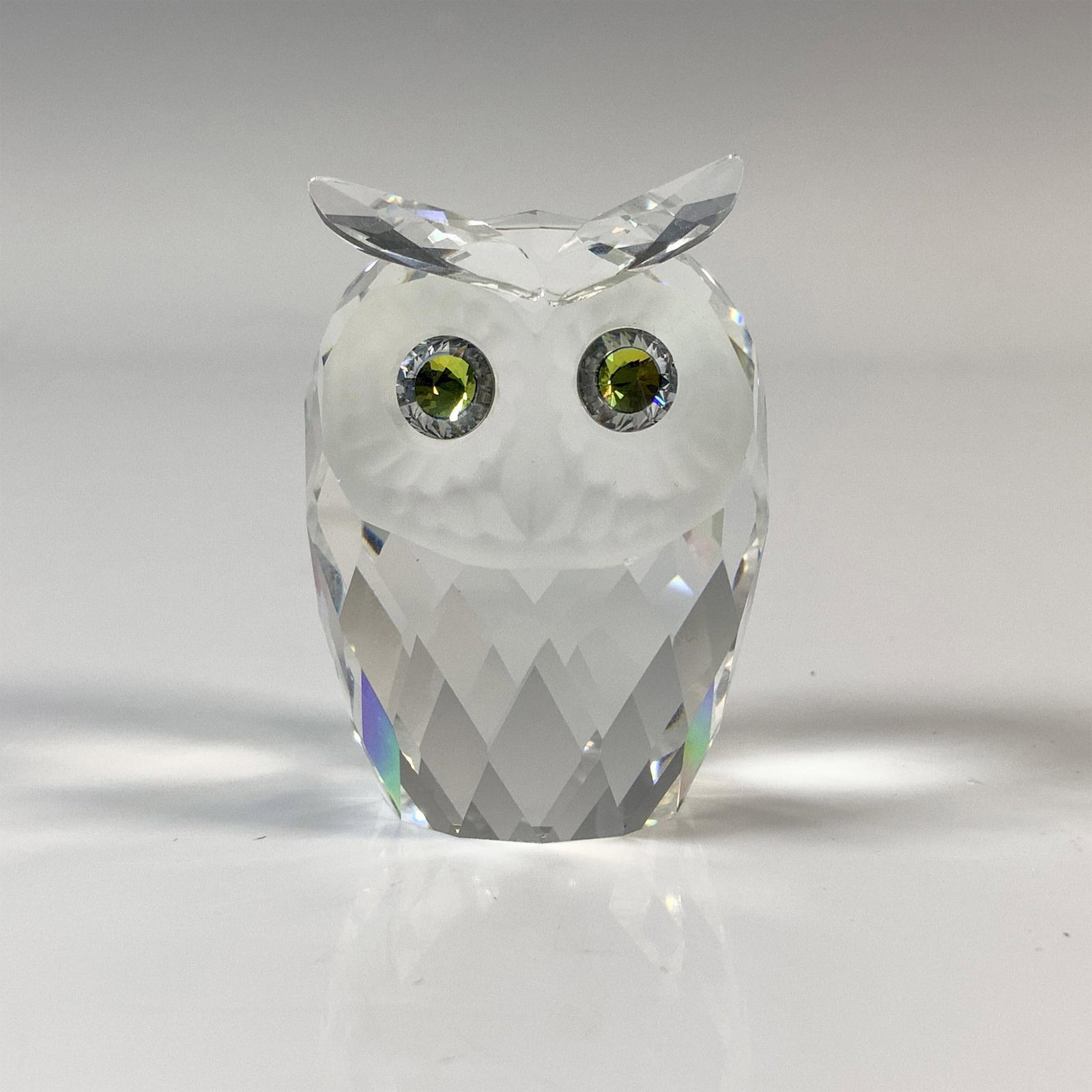 Swarovski Silver Crystal Owl Figurine, 7636 NR 046: The wise one has a clear cut crystal body, frosted face and sparkling yellow eyes. This item has its original box which measures 3.25"H x 3.75" dia. Acid etched Swarovski backstamp. Issued: 20th Centu