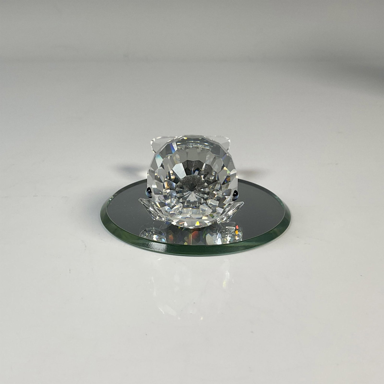 Swarovski Crystal Figurine, Smiley Whale + Mirror Base: This cheerful crystal whale is made from clear crystal and has green/black eyes and a frosted mouth. This item has its original box which measures 6.5"H x 3.5"dia. Includes a circular mirror base. Swa