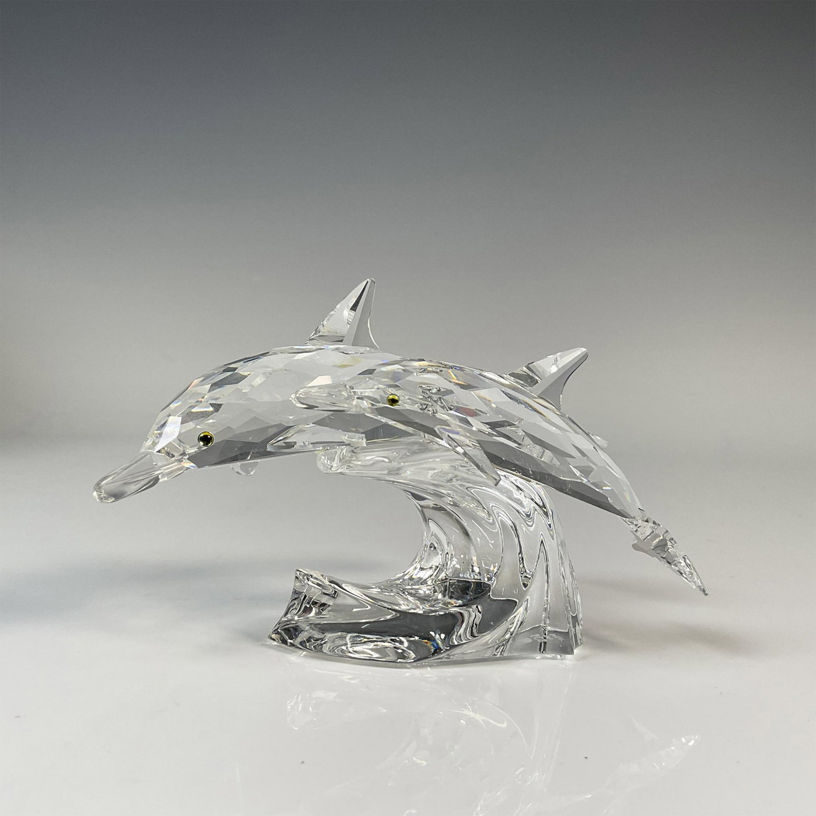 Swarovski Crystal Figurine, SCS Dolphins Lead Me: Beautiful lead clear crystal scene of the Mother and Child trilogy. Includes the original box, dimensions: 7.5''H x 7.5''dia. Includes the original certificate. Swarovski backstamp. Artist: Michael St