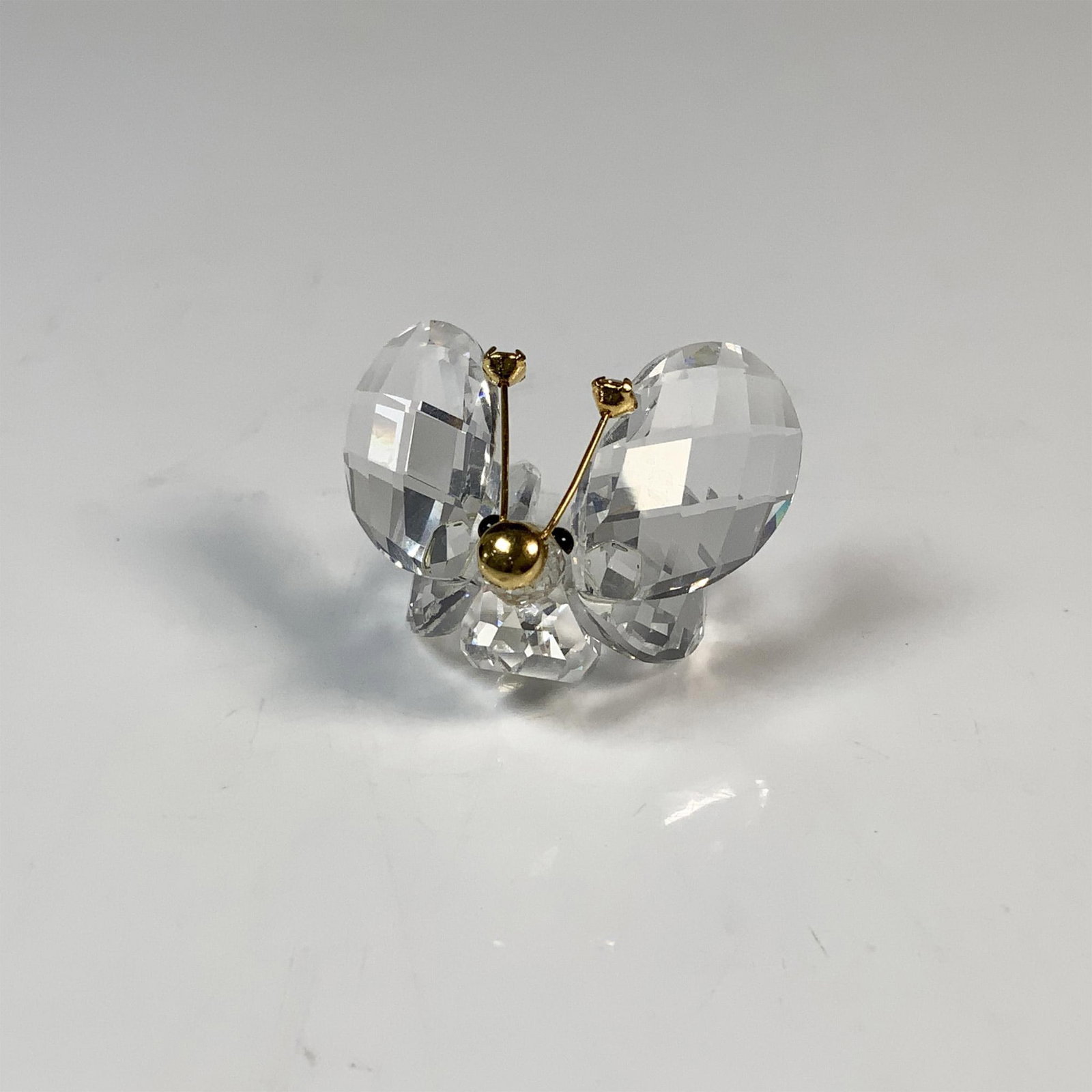 Swarovski Silver Crystal Butterfly Figurine, 7671 NR 30: Beautifully sculpted with a clear cut crystal body, black eyes and gold-toned nose and antennae. This item has its original box which measures 2.75"H x 2.5" dia. Acid etched Swarovski backstamp. Issue