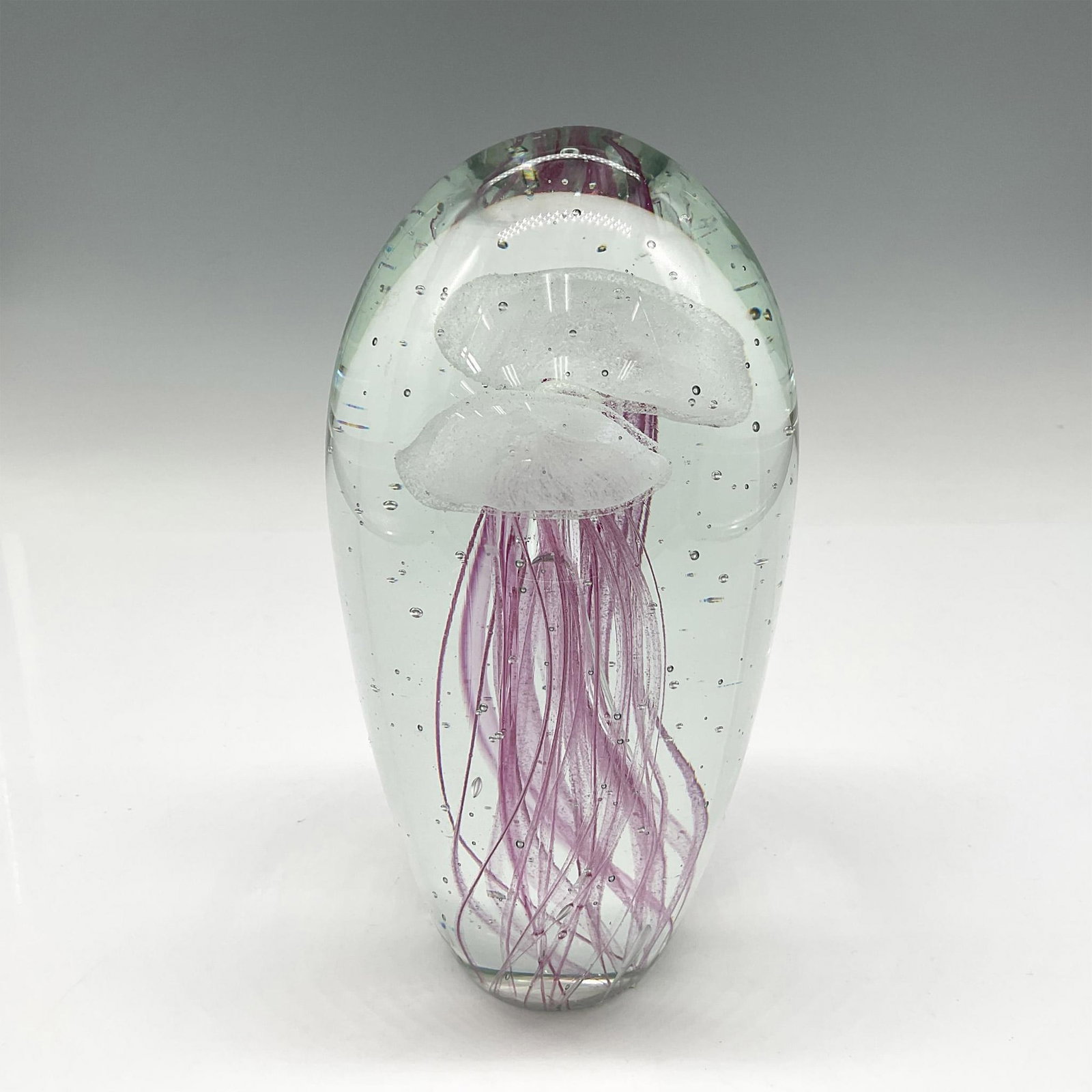 Hand Blown Art Glass, Jellyfish Paperweight: Clear cased glass with white jellyfish shapes, long tendrils colored pink. Issued: 20th century Dimensions: 6.75"H x 3.25" dia.